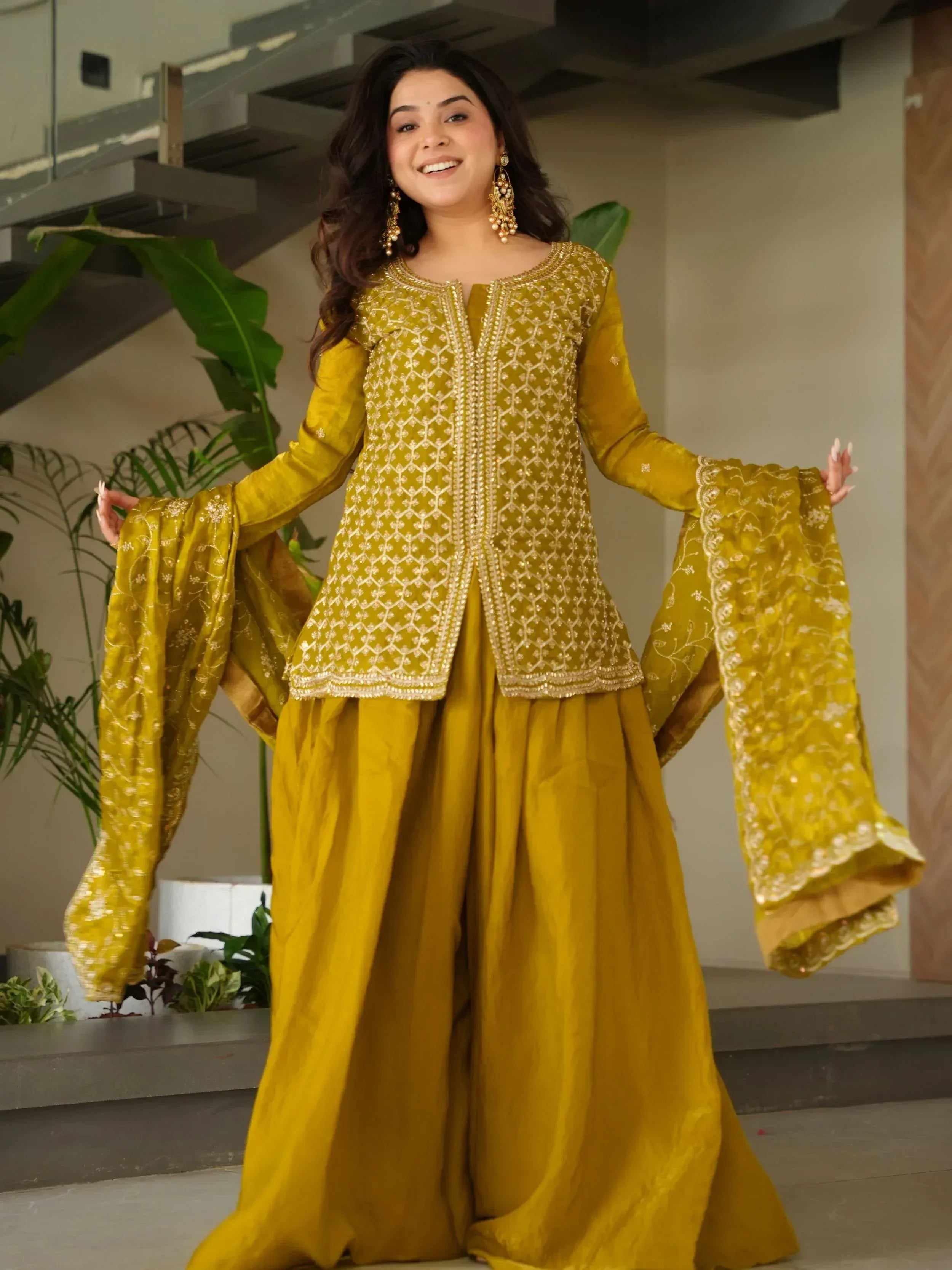 Mustard yellow ethnic sharara suit with gold embroidery, perfect for Indian occasions and festive wear.