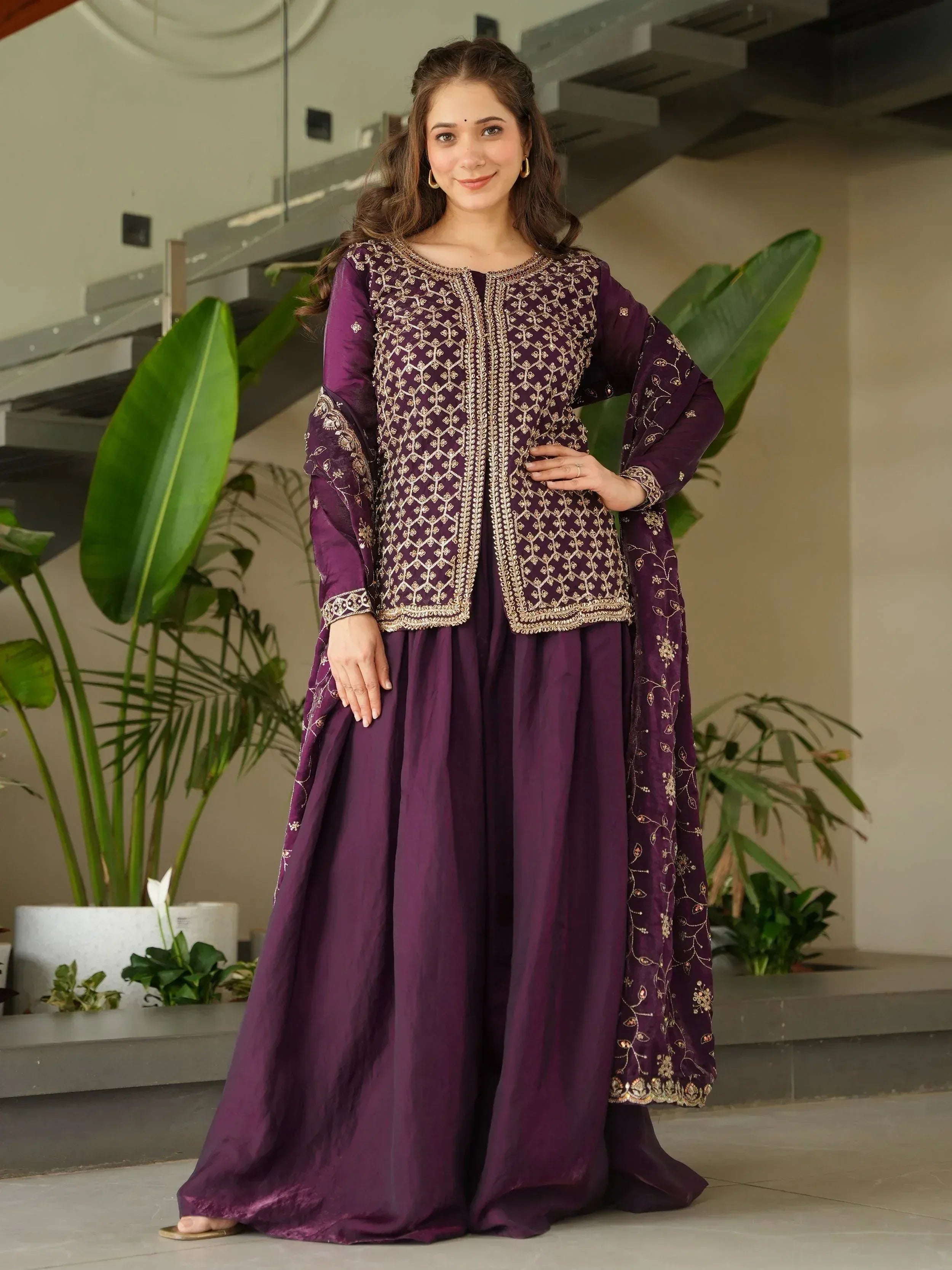 Purple embroidered ethnic gown with gold detailing, perfect for Indian occasions and festive wear.