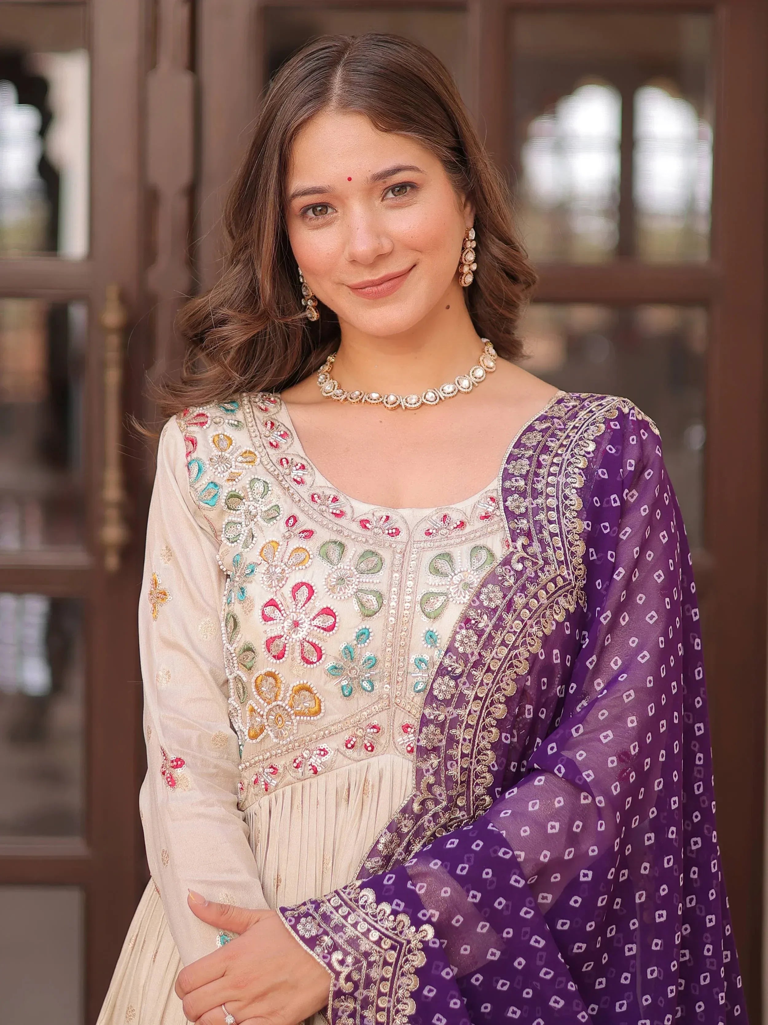 Woman in embroidered Indian salwar kameez with purple dupatta, traditional ethnic wear