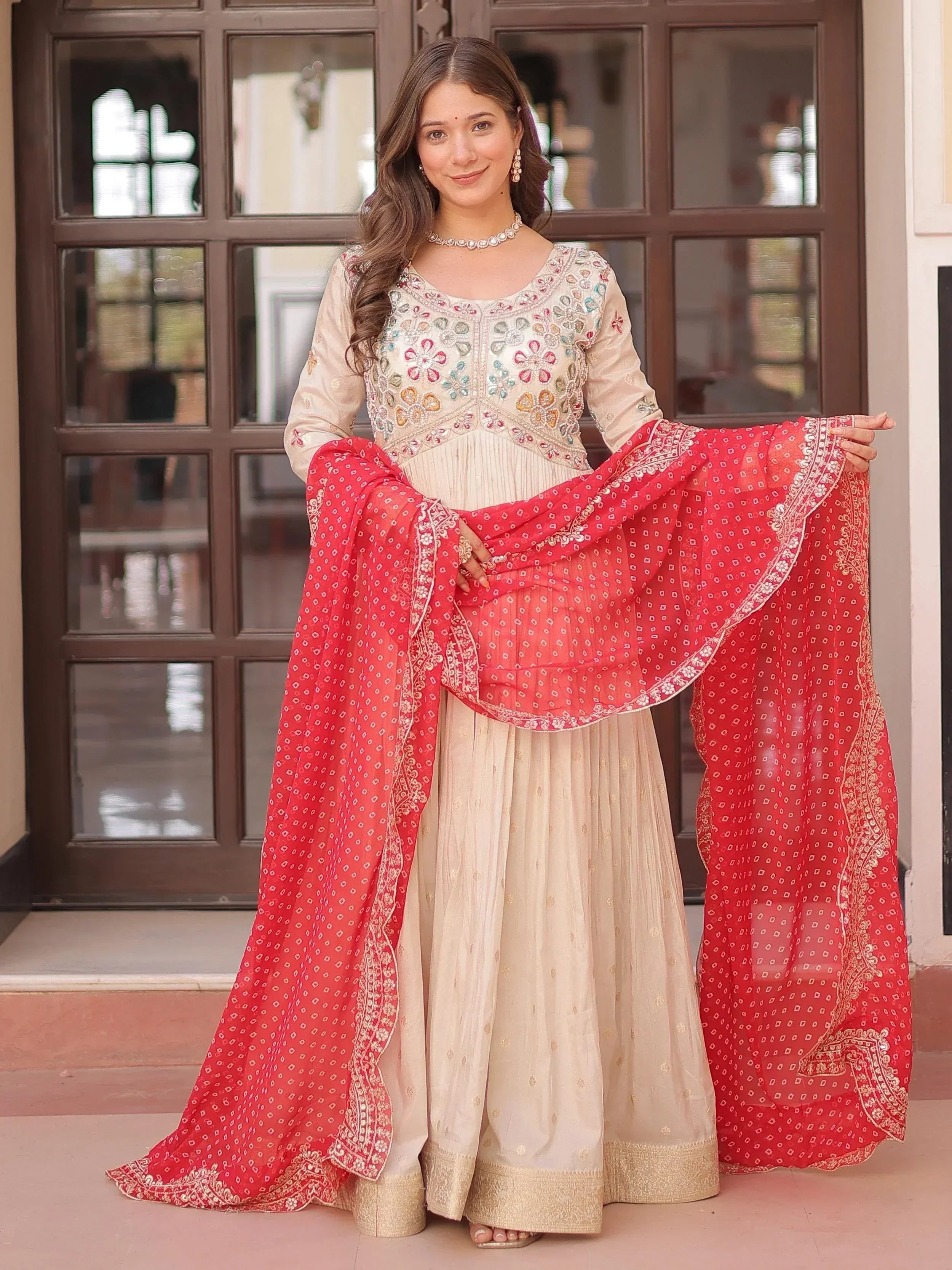 Elegant cream embroidered salwar kameez with red dupatta, perfect for Indian ethnic wear occasions.