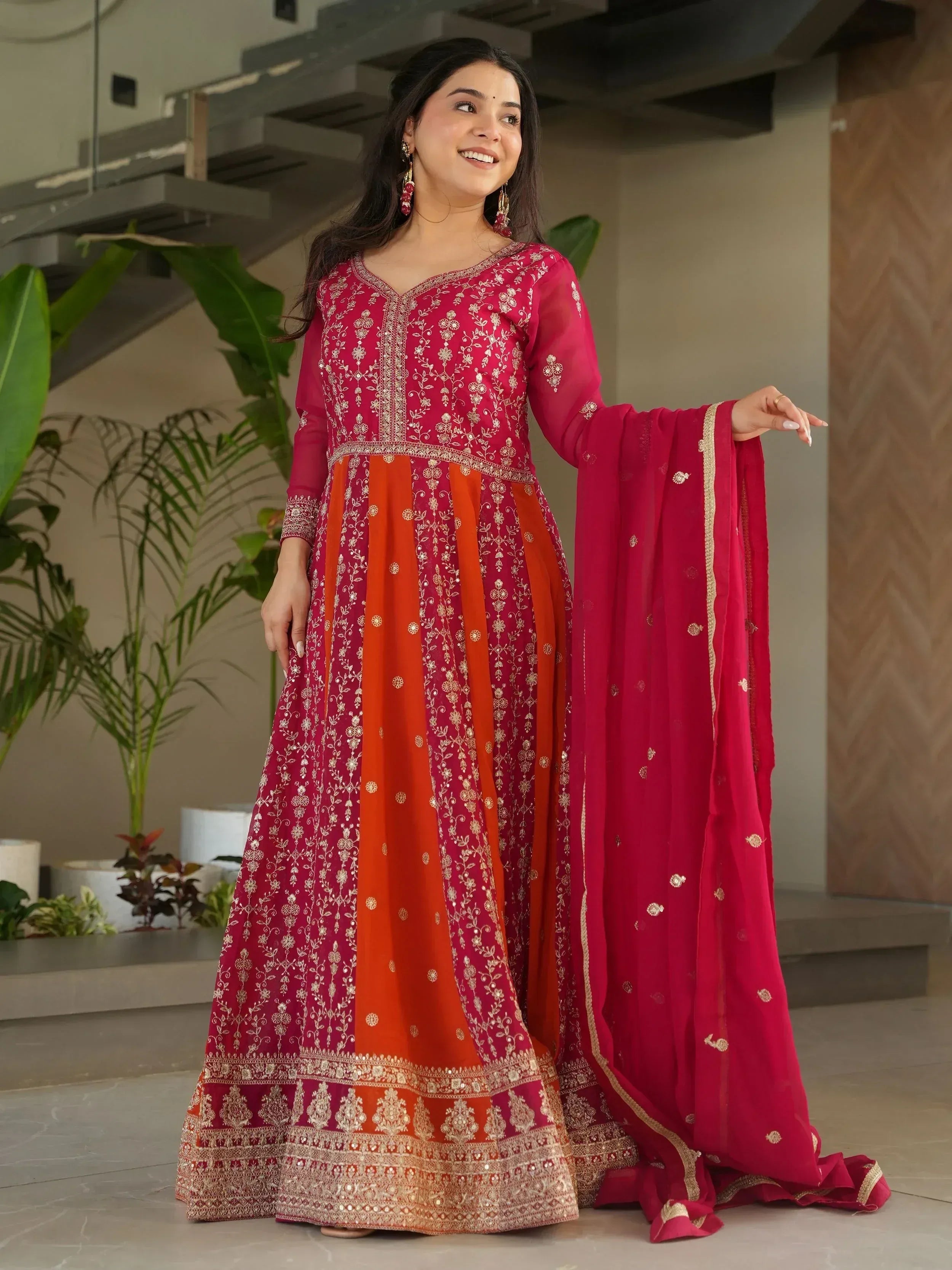 Red and orange embroidered Anarkali suit with gold detailing, perfect for Indian ethnic wear occasions.
