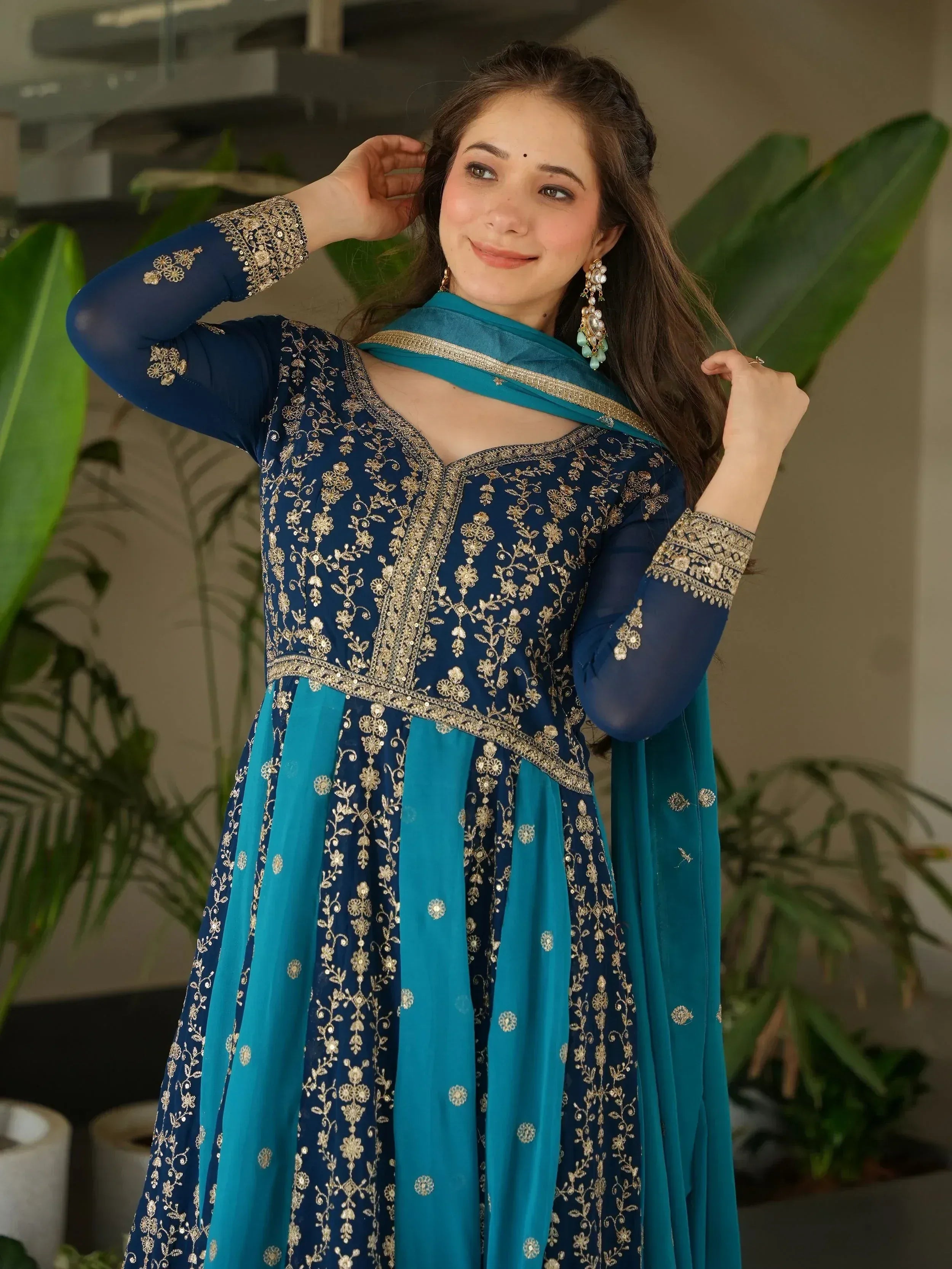 Blue and teal embroidered Indian anarkali suit with gold floral work, perfect for festive occasions.