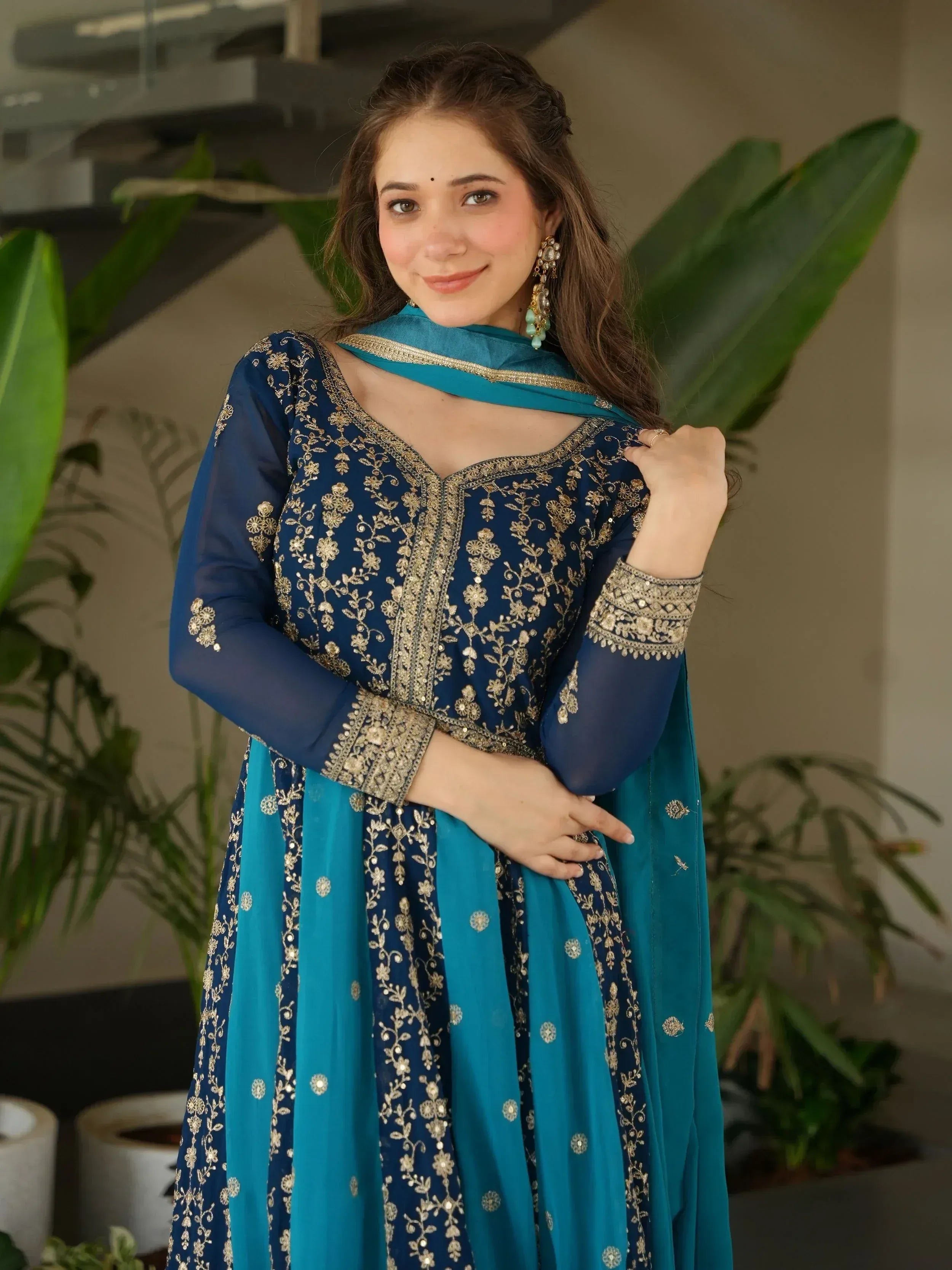 Blue and teal embroidered Indian salwar kameez with gold floral work, perfect for festive occasions.