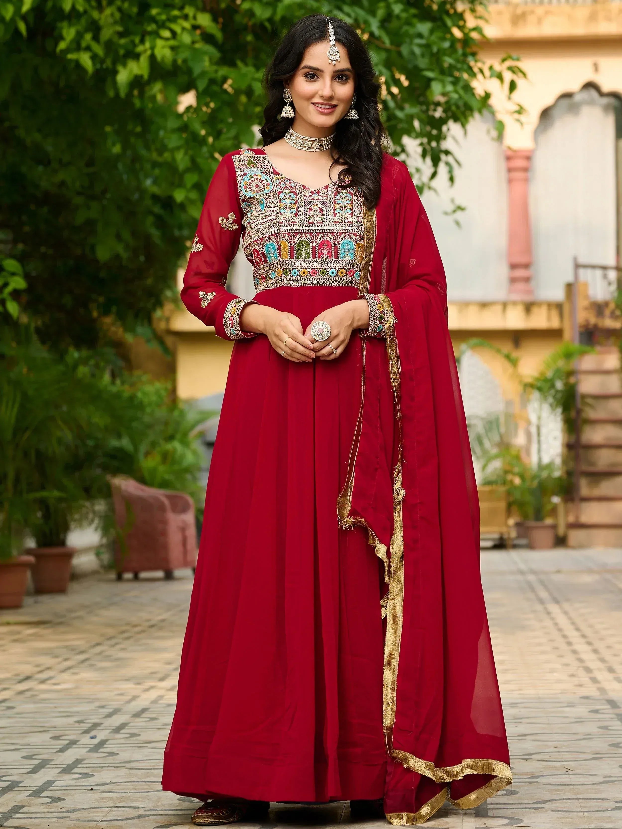 Woman in maroon embroidered anarkali suit with gold trim, perfect for Indian ethnic wear occasions