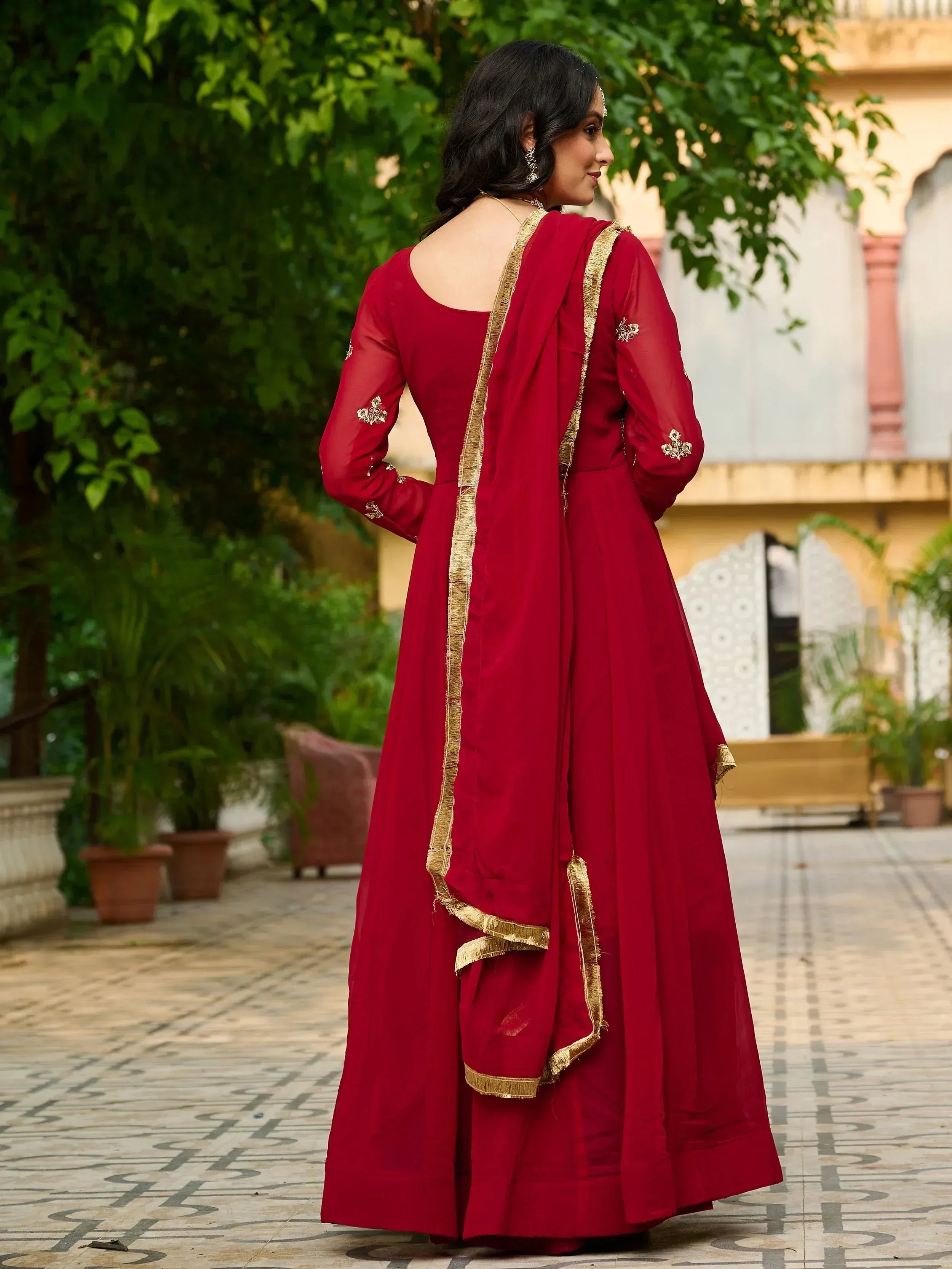 Red ethnic anarkali with gold trim, perfect for Indian weddings and festive occasions