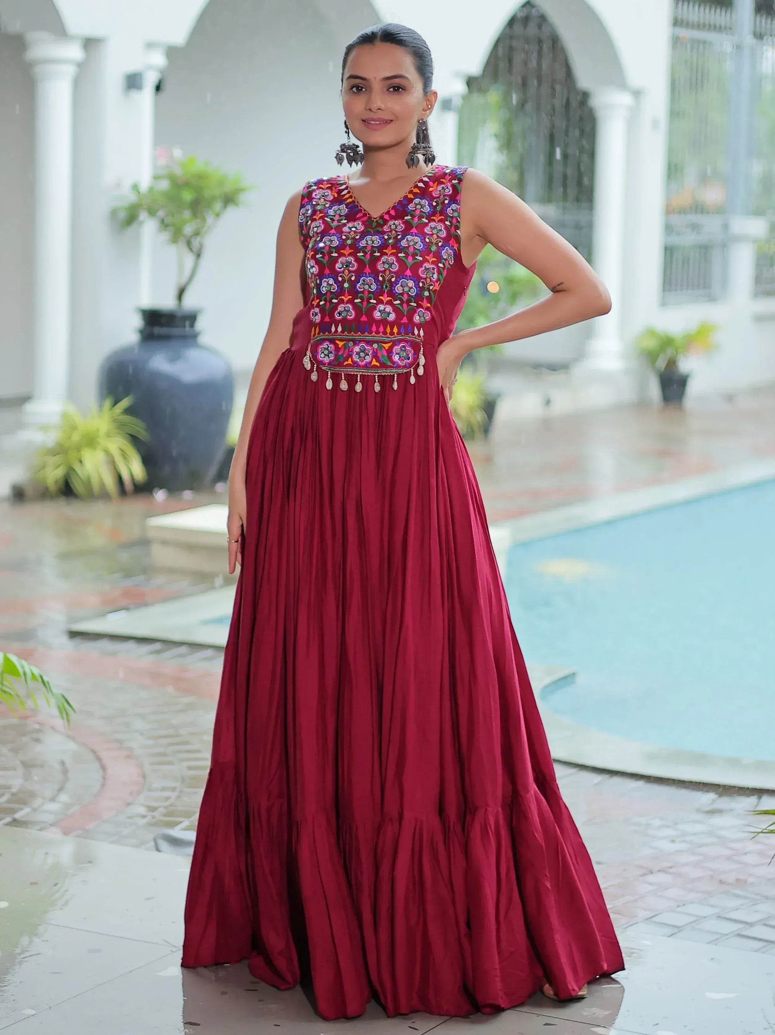 Maroon ethnic gown with colorful floral embroidery, perfect for Indian festive occasions