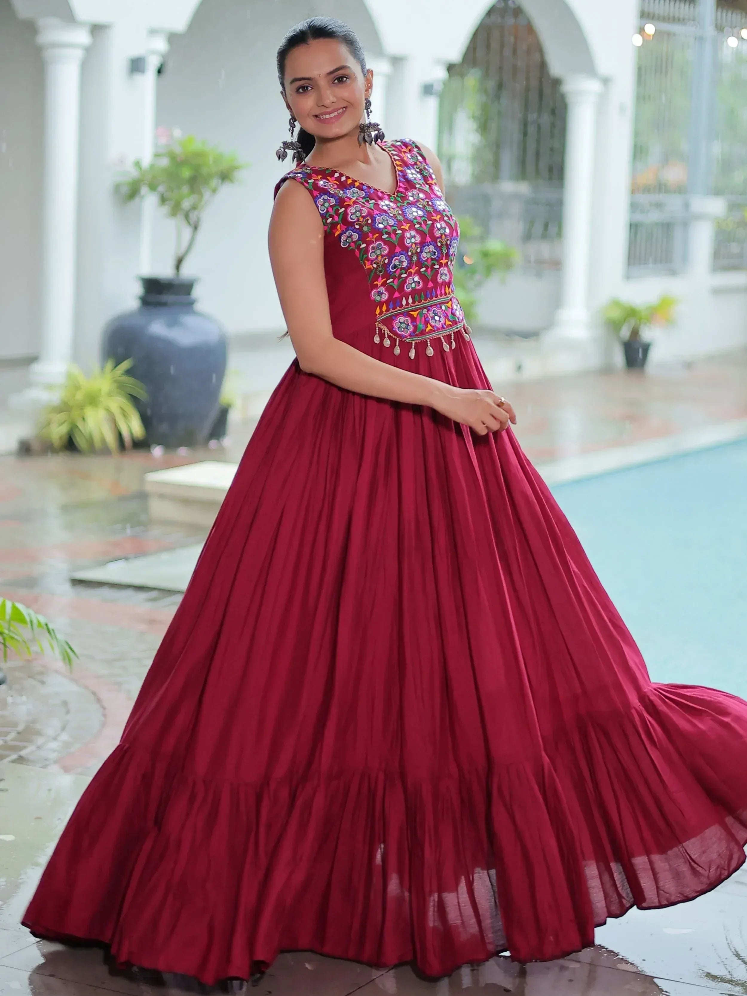 Woman in maroon ethnic gown with floral embroidery, perfect for Indian festive occasions
