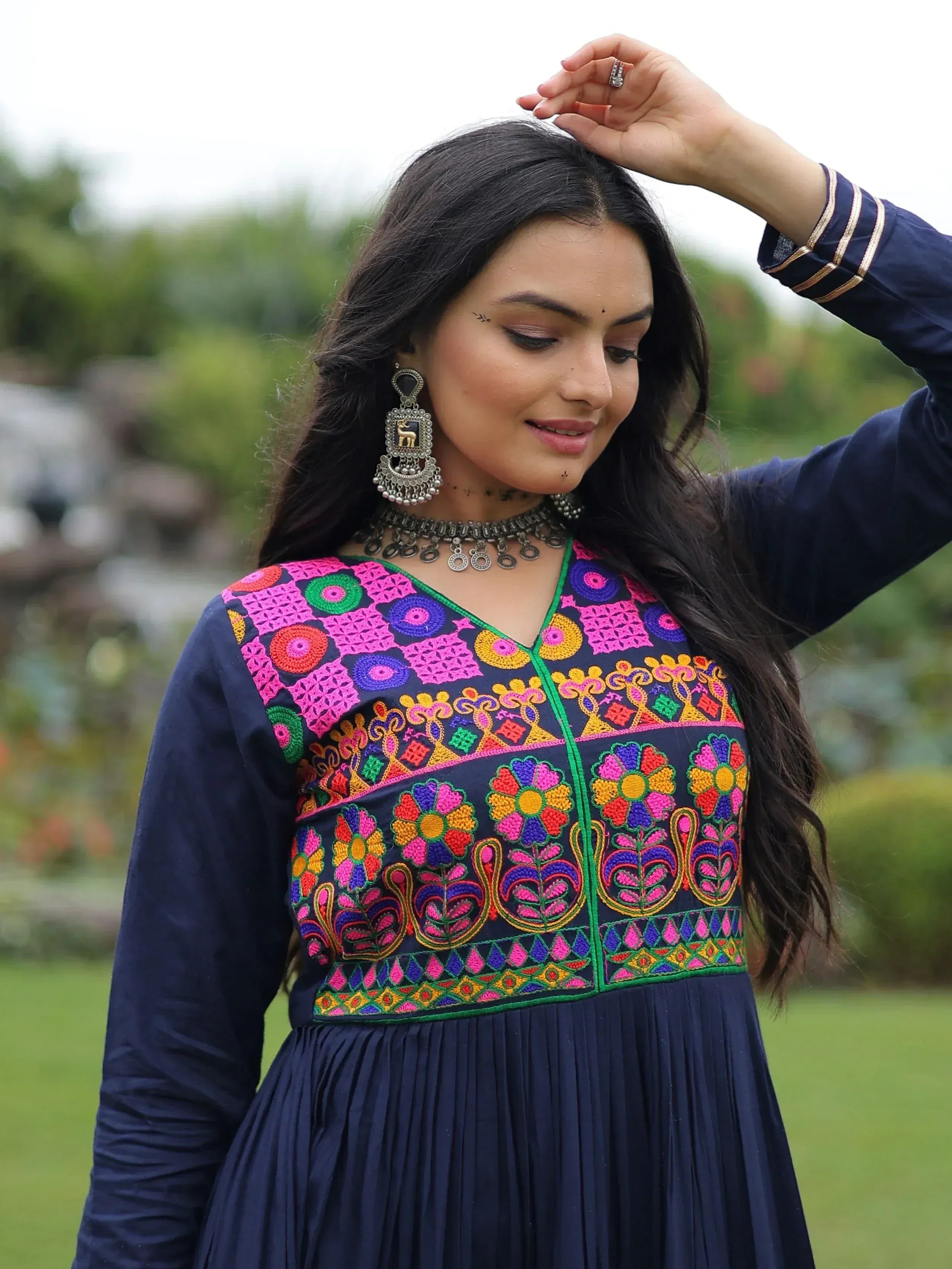 Navy blue ethnic gown with vibrant floral embroidery, perfect for Indian occasions and festive wear.
