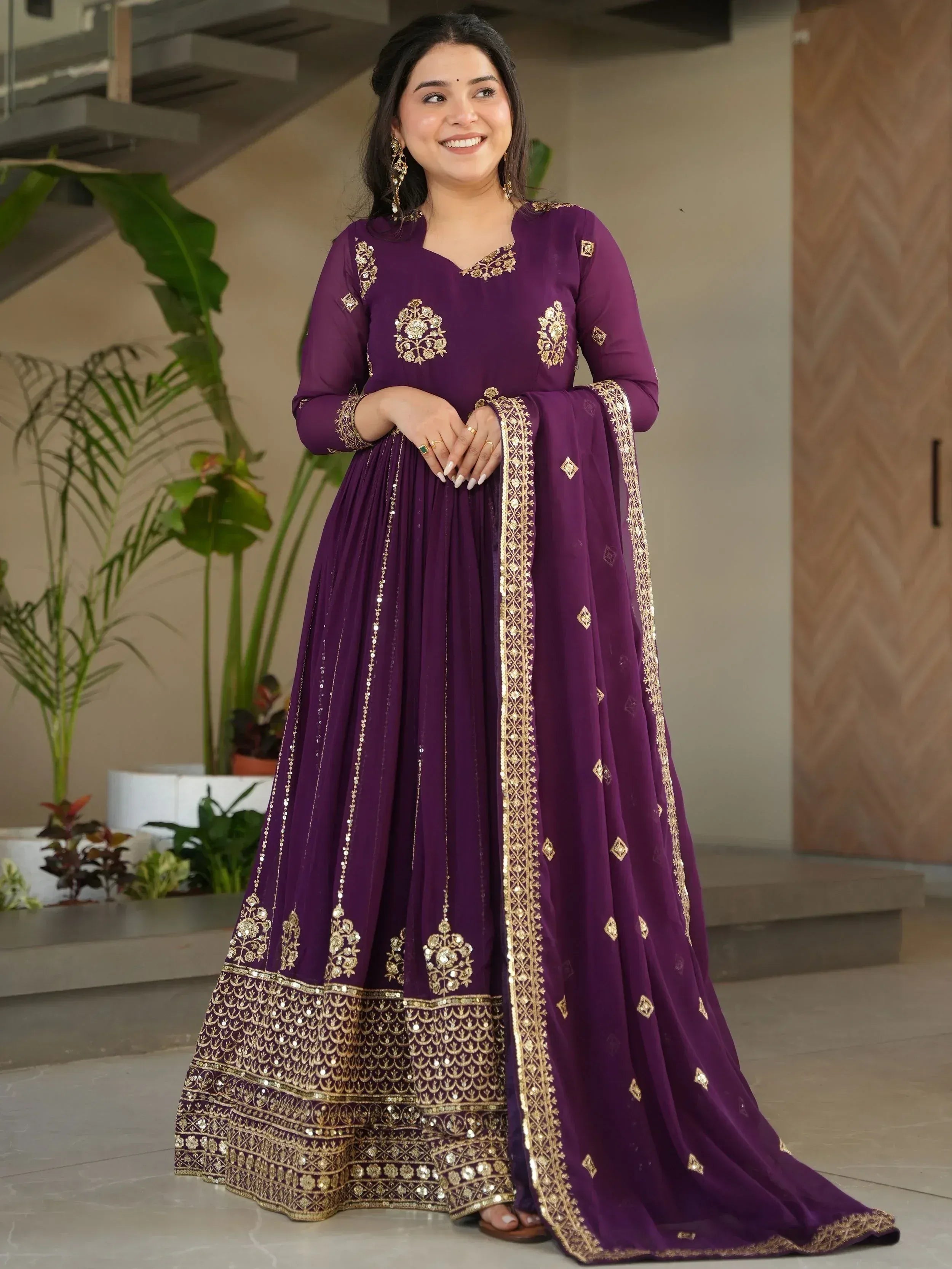 Purple ethnic gown with gold embroidery, perfect for Indian celebrations and festive occasions.