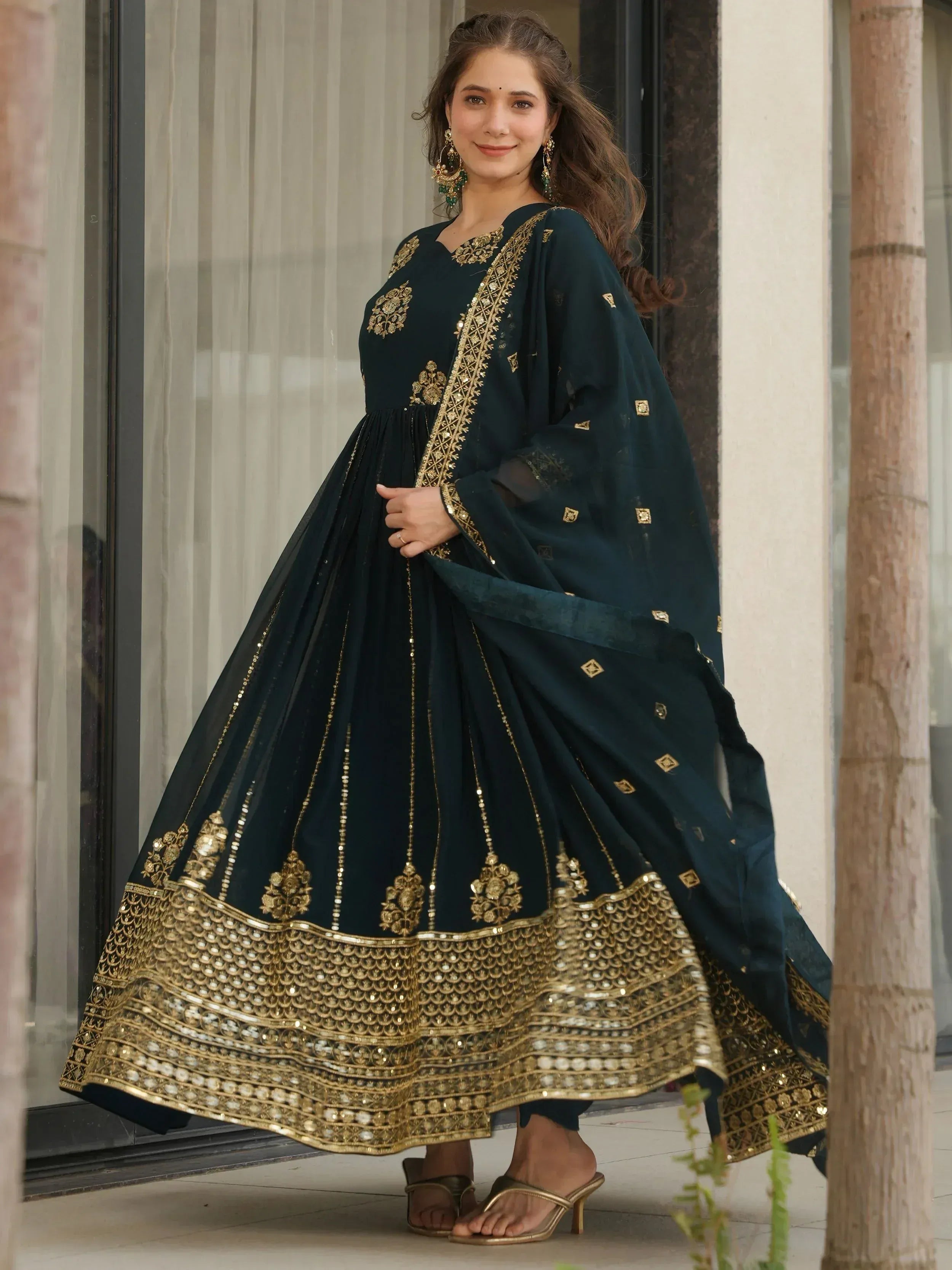 Elegant dark green anarkali with gold embroidery and sequin detailing, perfect for Indian ethnic occasions.