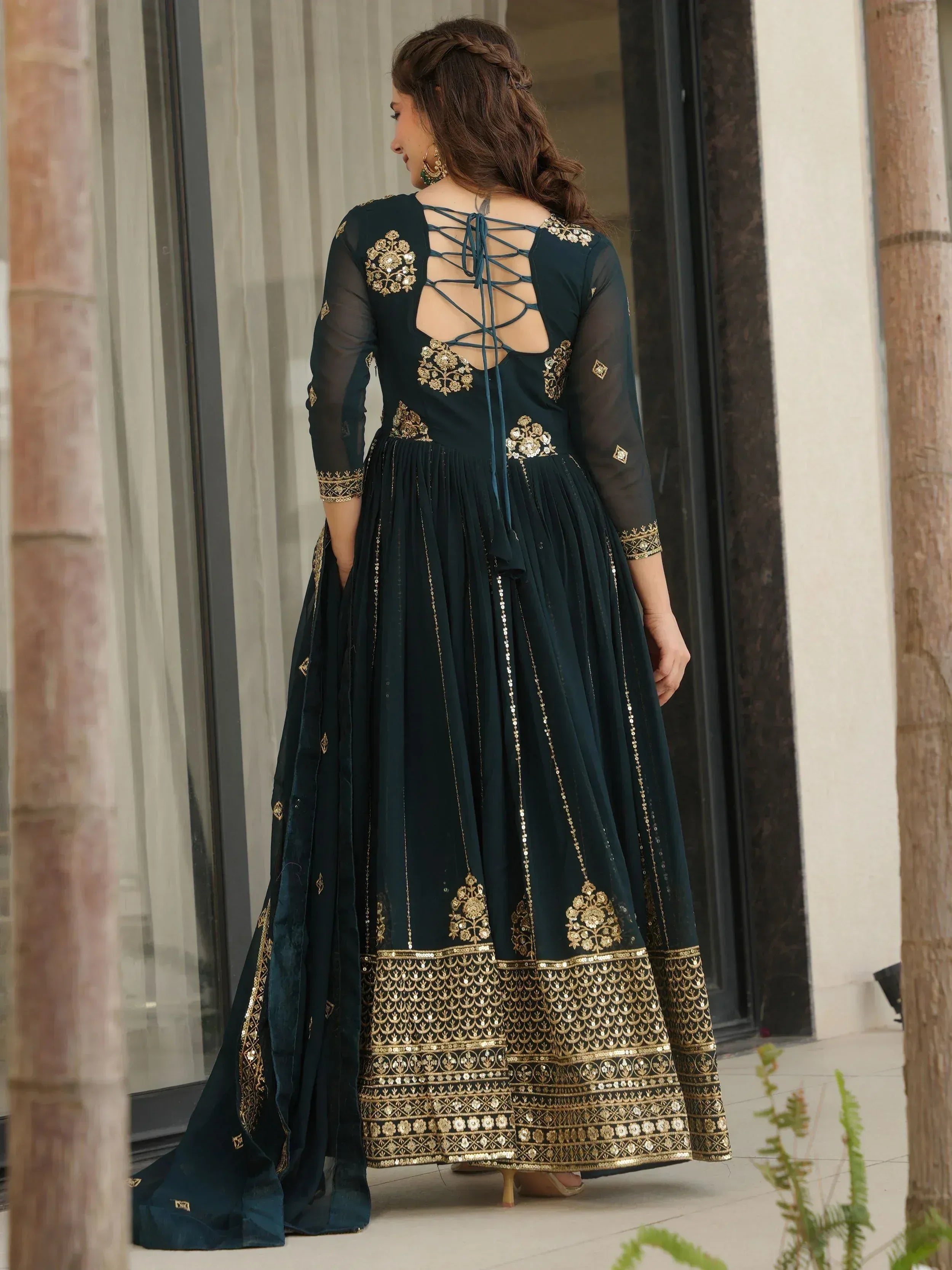 Elegant dark green anarkali with gold embroidery and lace-up back, perfect for Indian ethnic wear.