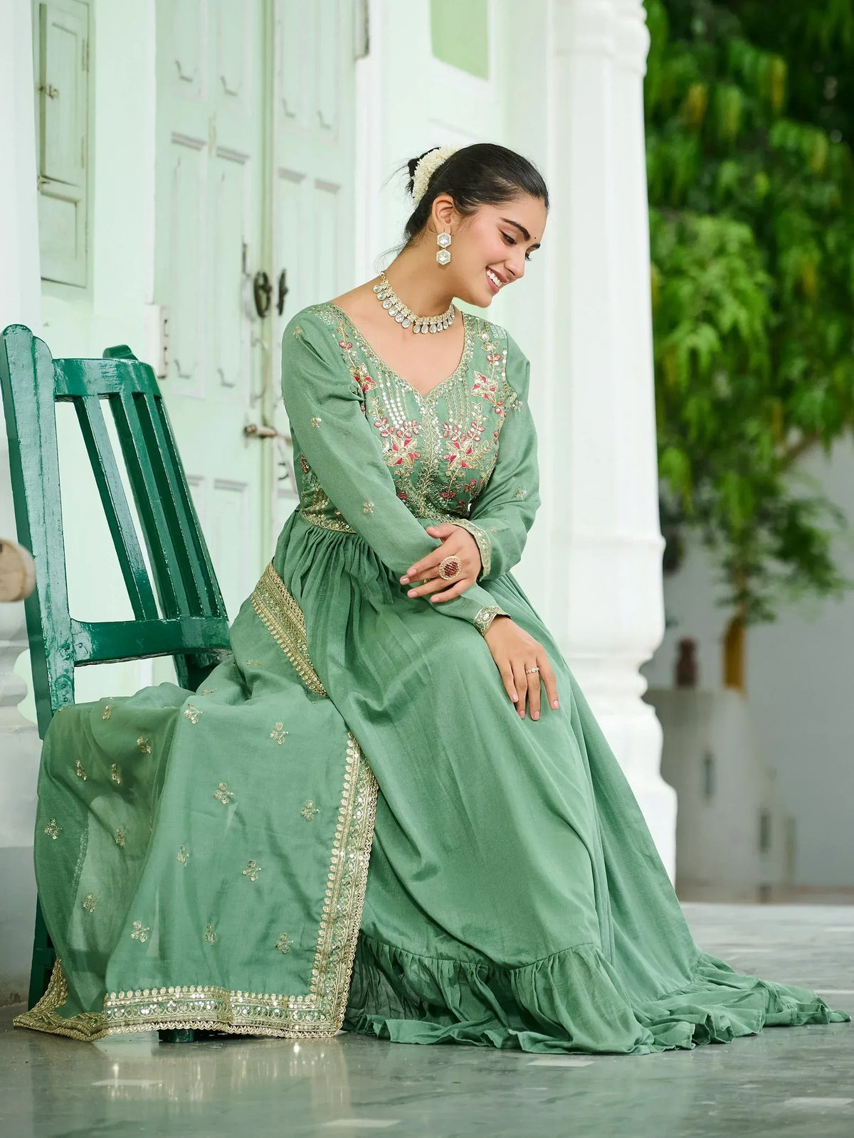 Elegant green embroidered ethnic gown with gold detailing, perfect for Indian celebrations
