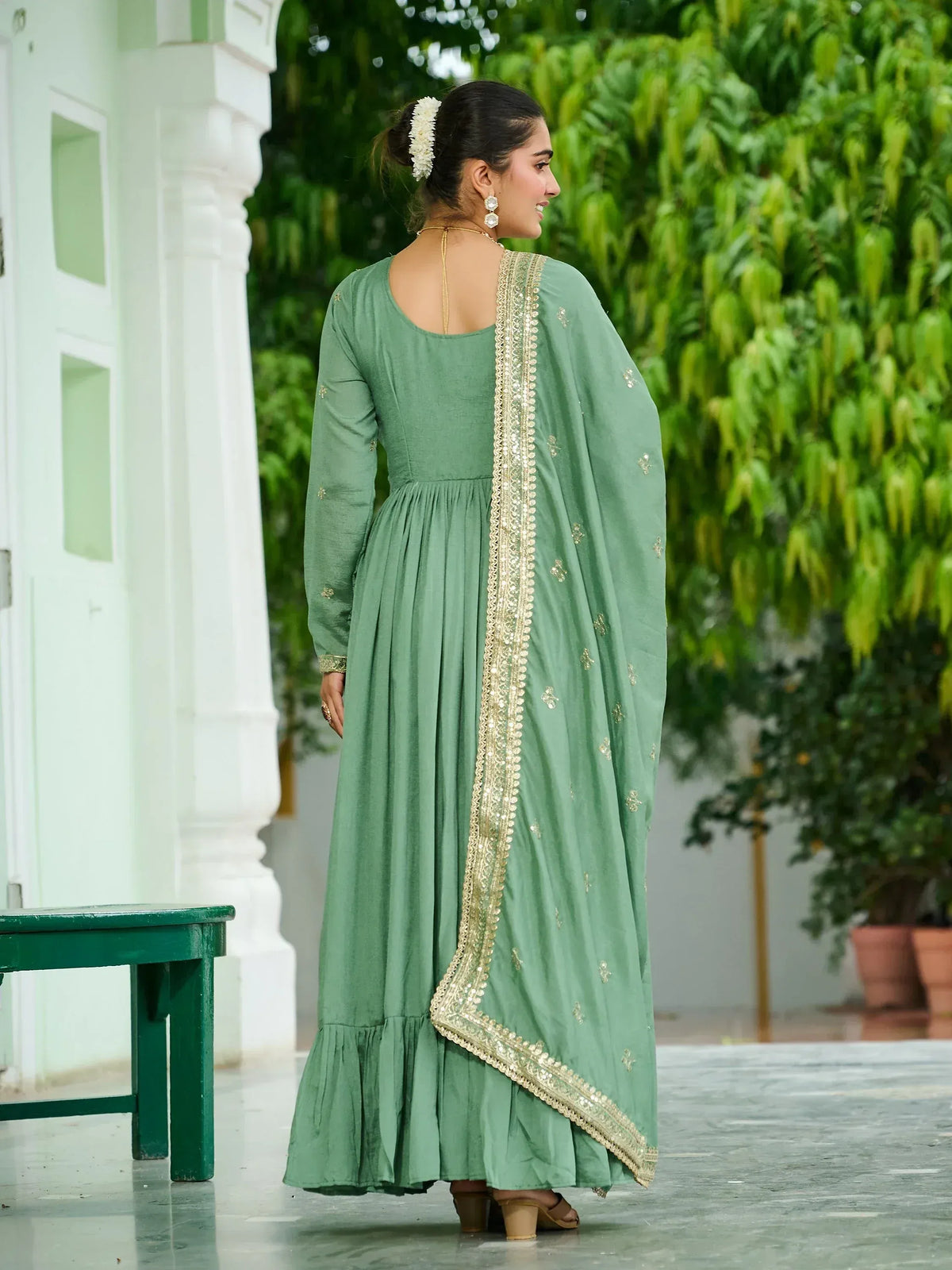 Green ethnic gown with gold embroidery, perfect for Indian festive wear
