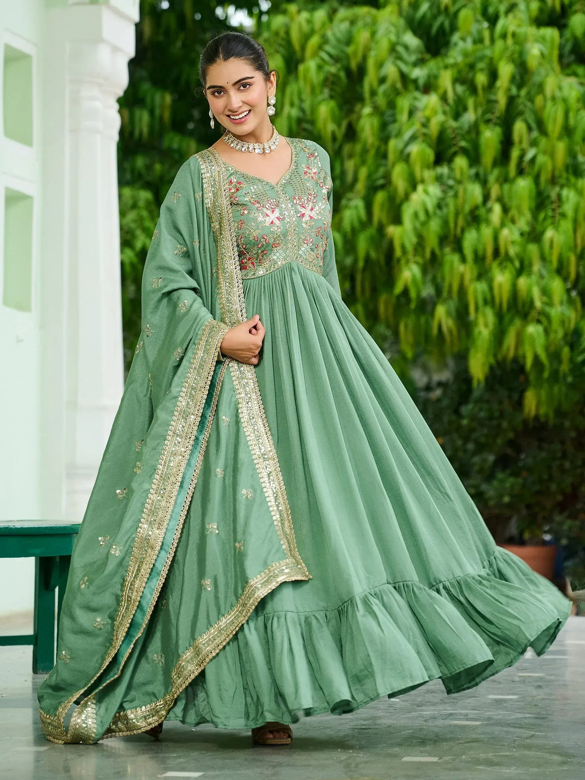 Elegant green embroidered anarkali gown with gold detailing, perfect for Indian ethnic wear occasions.