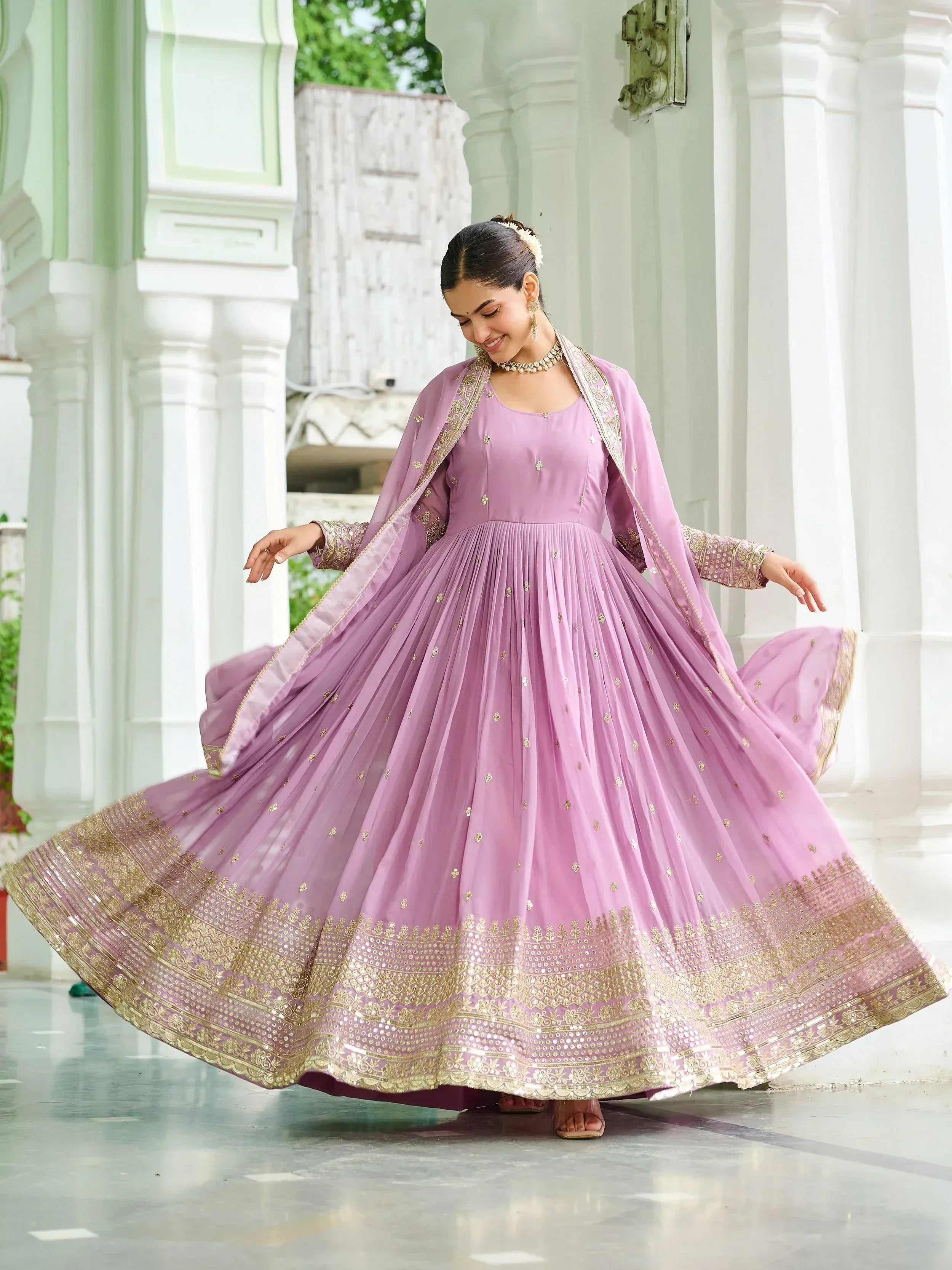 Elegant lavender ethnic gown with gold embroidery, perfect for Indian celebrations