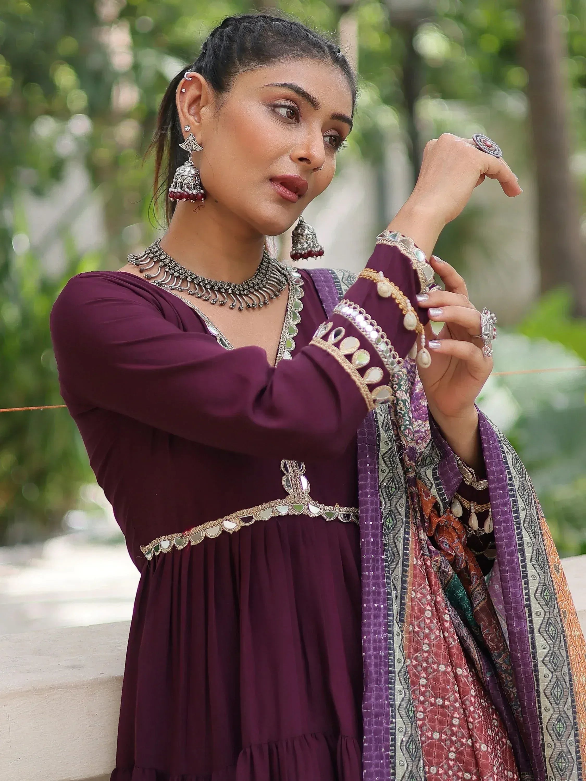 Elegant maroon ethnic gown with mirror work and traditional jewelry for Indian festive wear
