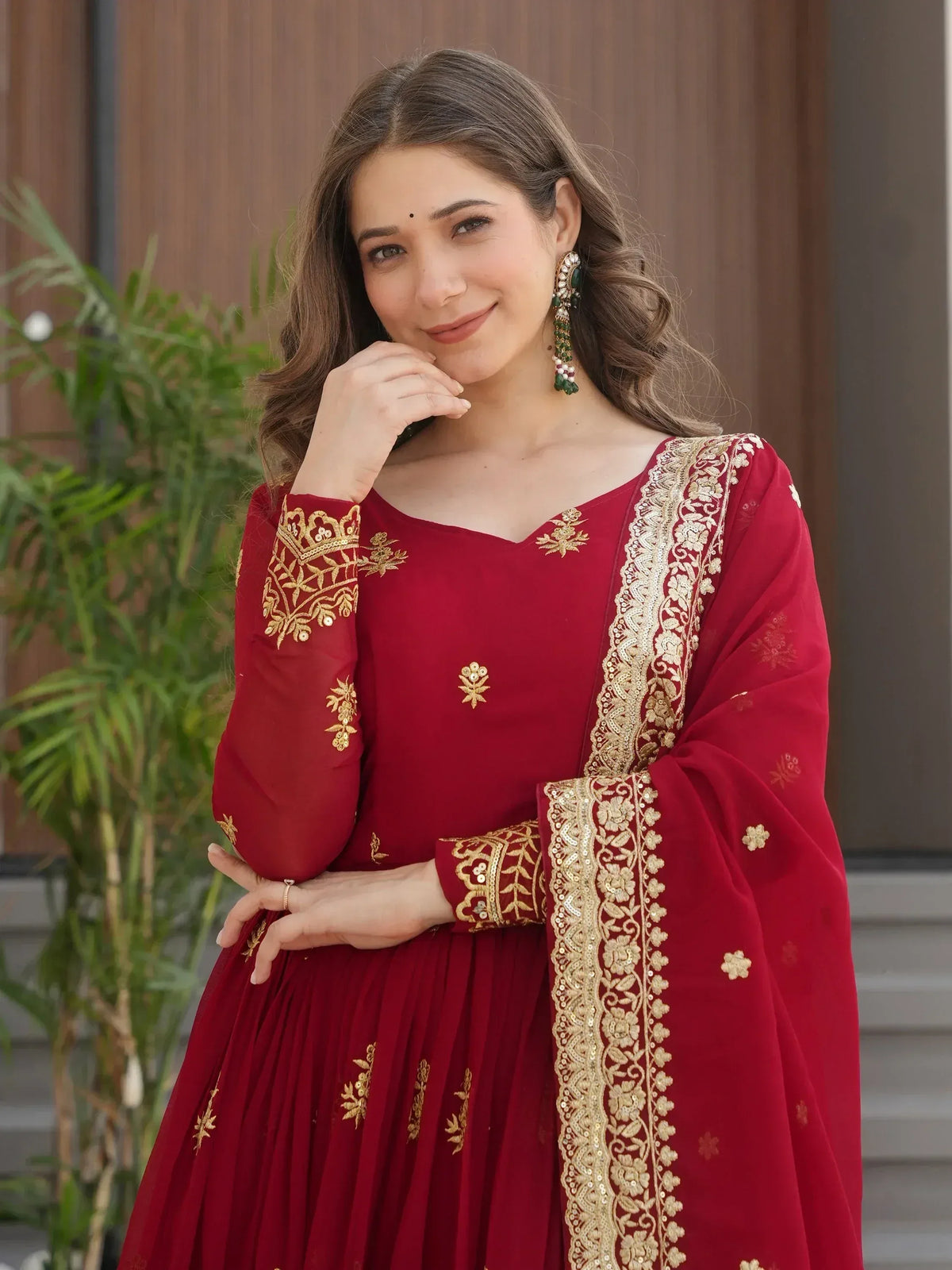 Red embroidered Indian ethnic gown with gold detailing, perfect for festive occasions and weddings.