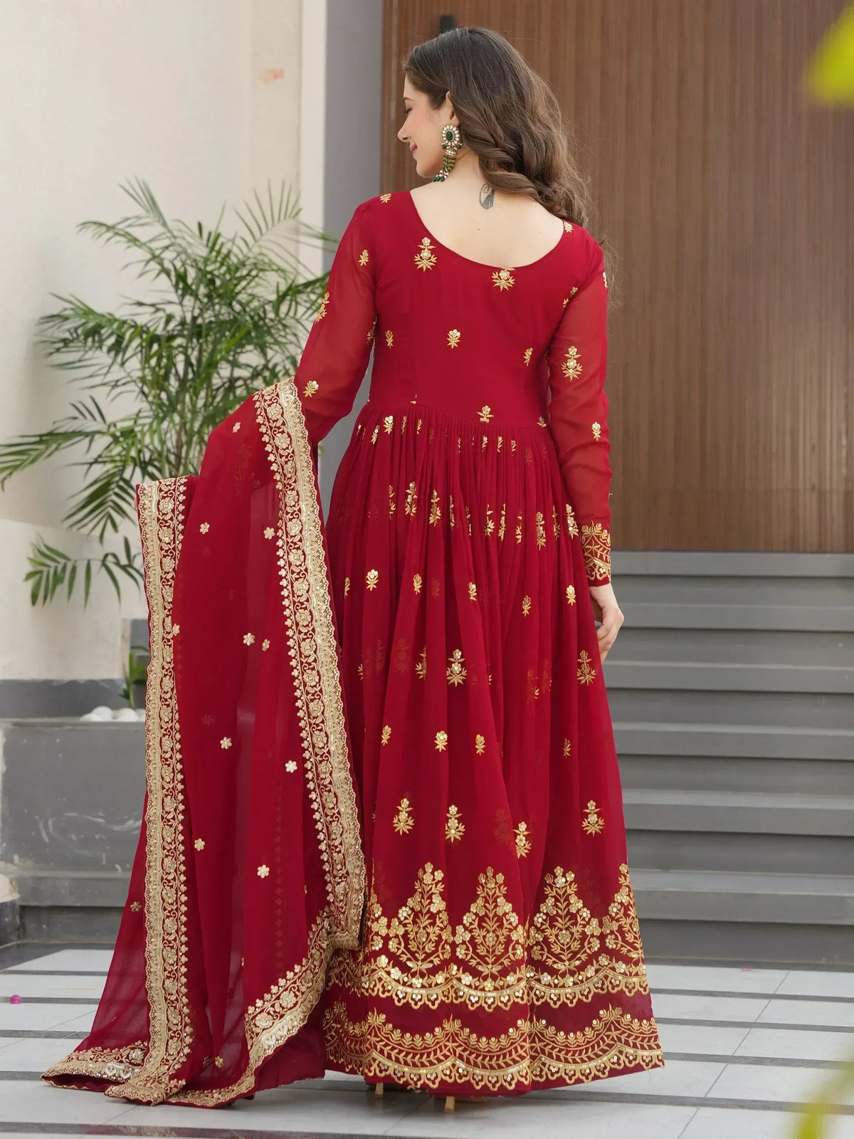 Red ethnic anarkali suit with gold embroidery and matching dupatta, perfect for Indian weddings and festive occasions.
