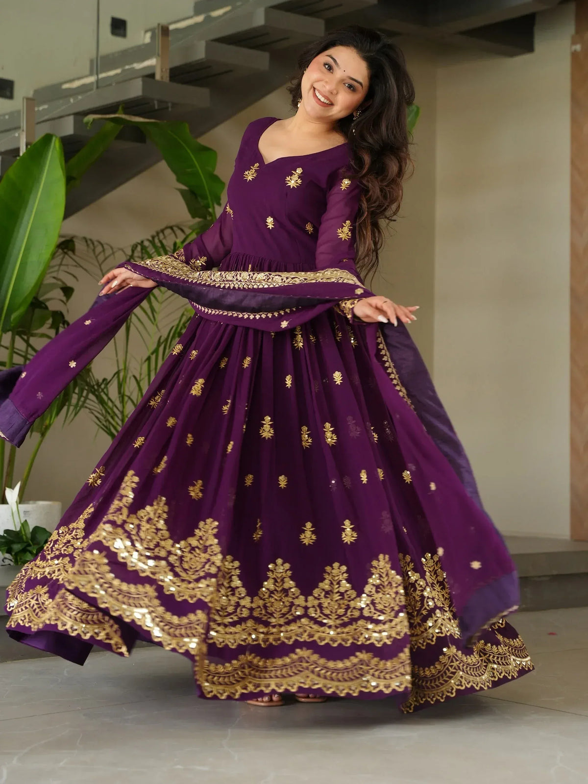 Purple ethnic gown with gold embroidery, perfect for Indian occasions and festive wear.