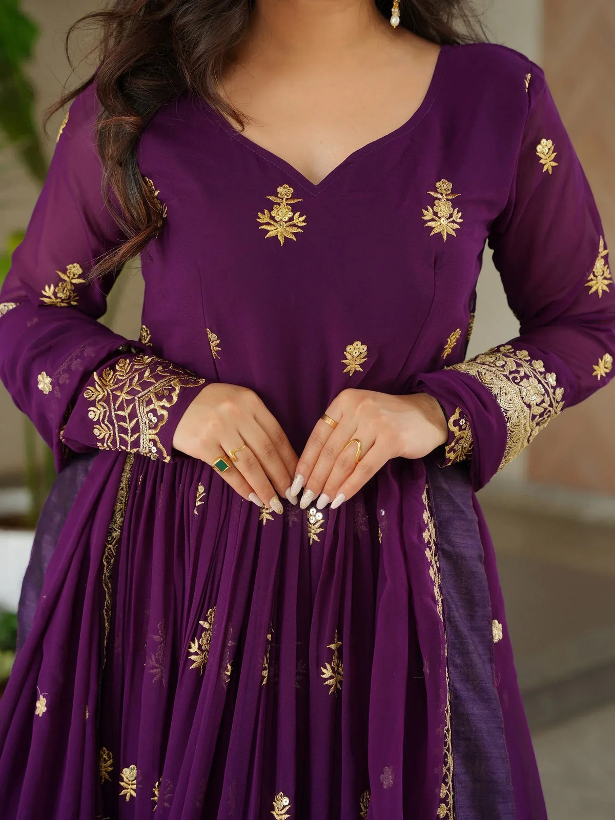Purple ethnic gown with gold floral embroidery, perfect for Indian occasions and festive wear.