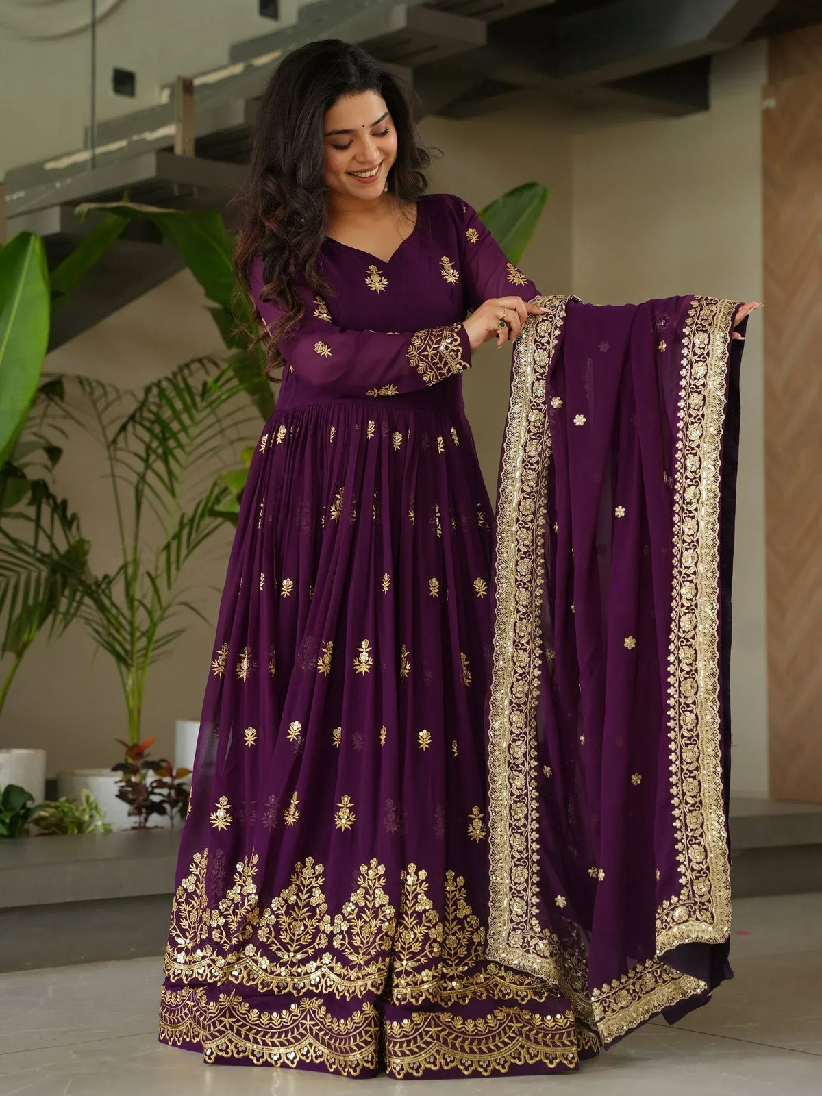 Purple ethnic anarkali with gold embroidery and matching dupatta, perfect for Indian weddings and festive occasions.