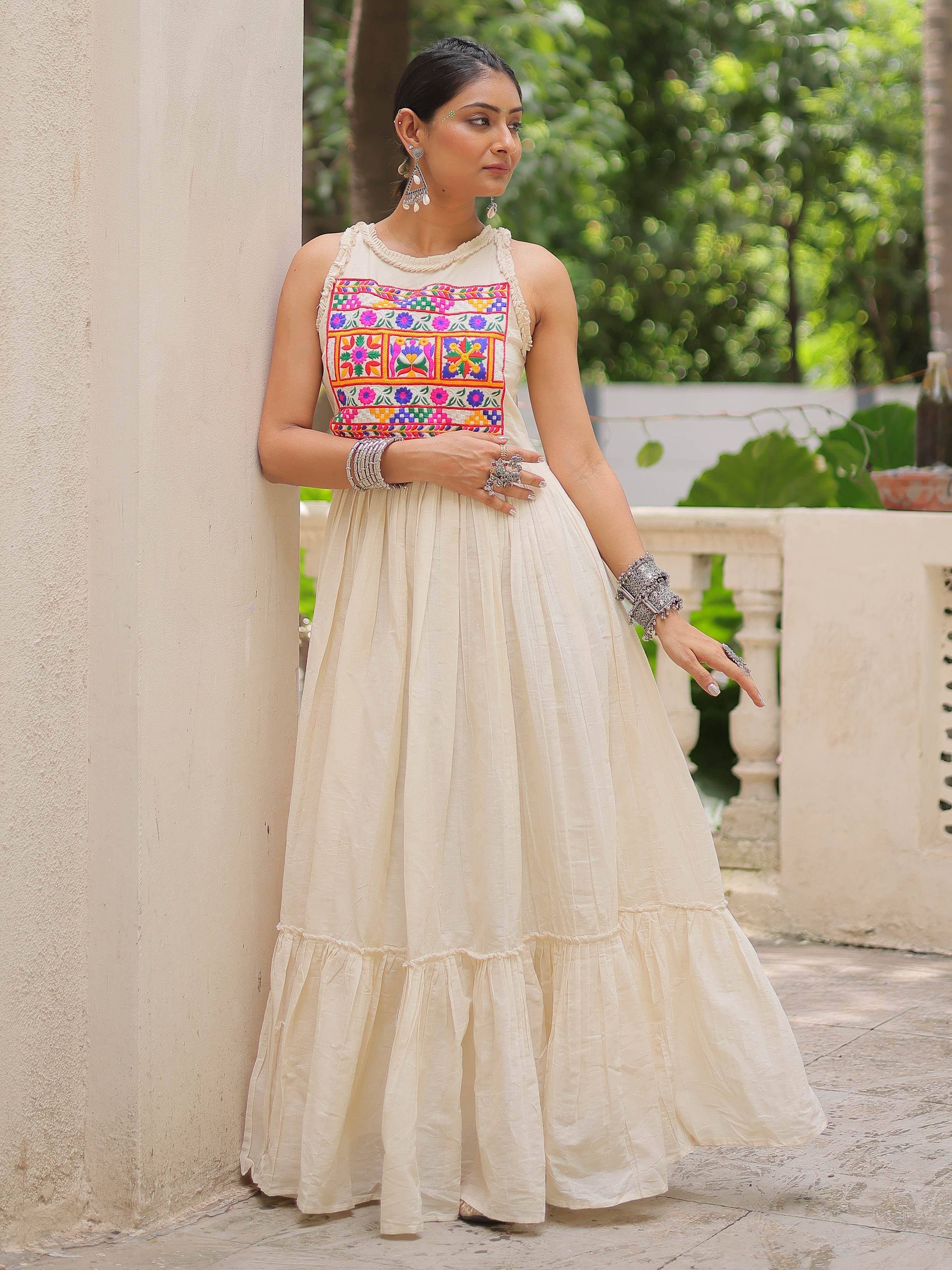 Cream ethnic gown with colorful floral embroidery, perfect for Indian occasions and festive wear.