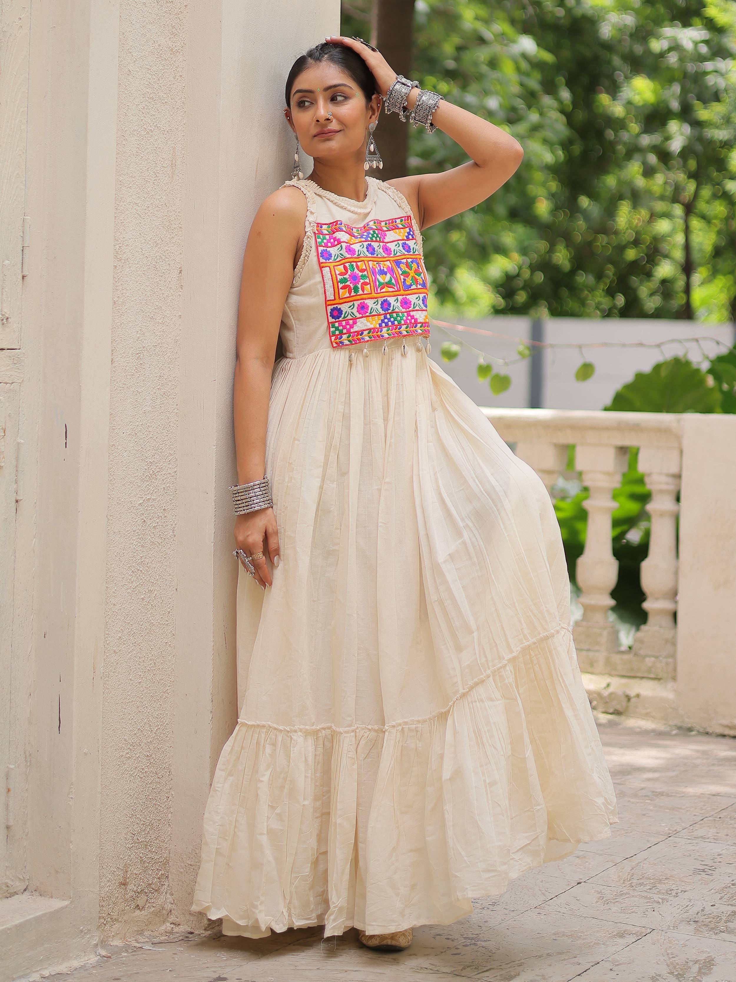 Cream ethnic gown with colorful floral embroidery, perfect for Indian festive occasions