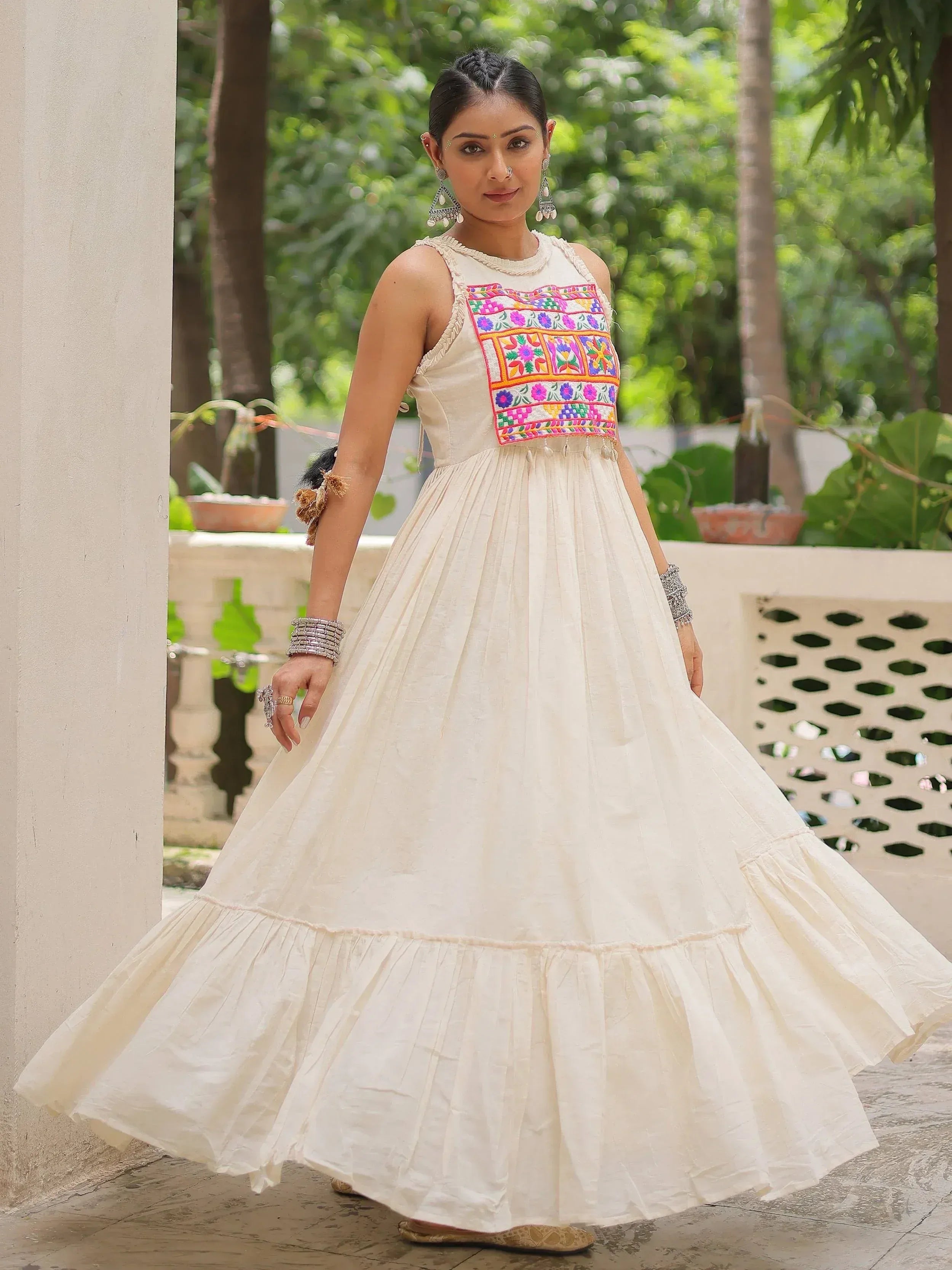 Cream ethnic gown with colorful floral embroidery, perfect for Indian occasions and festive wear.