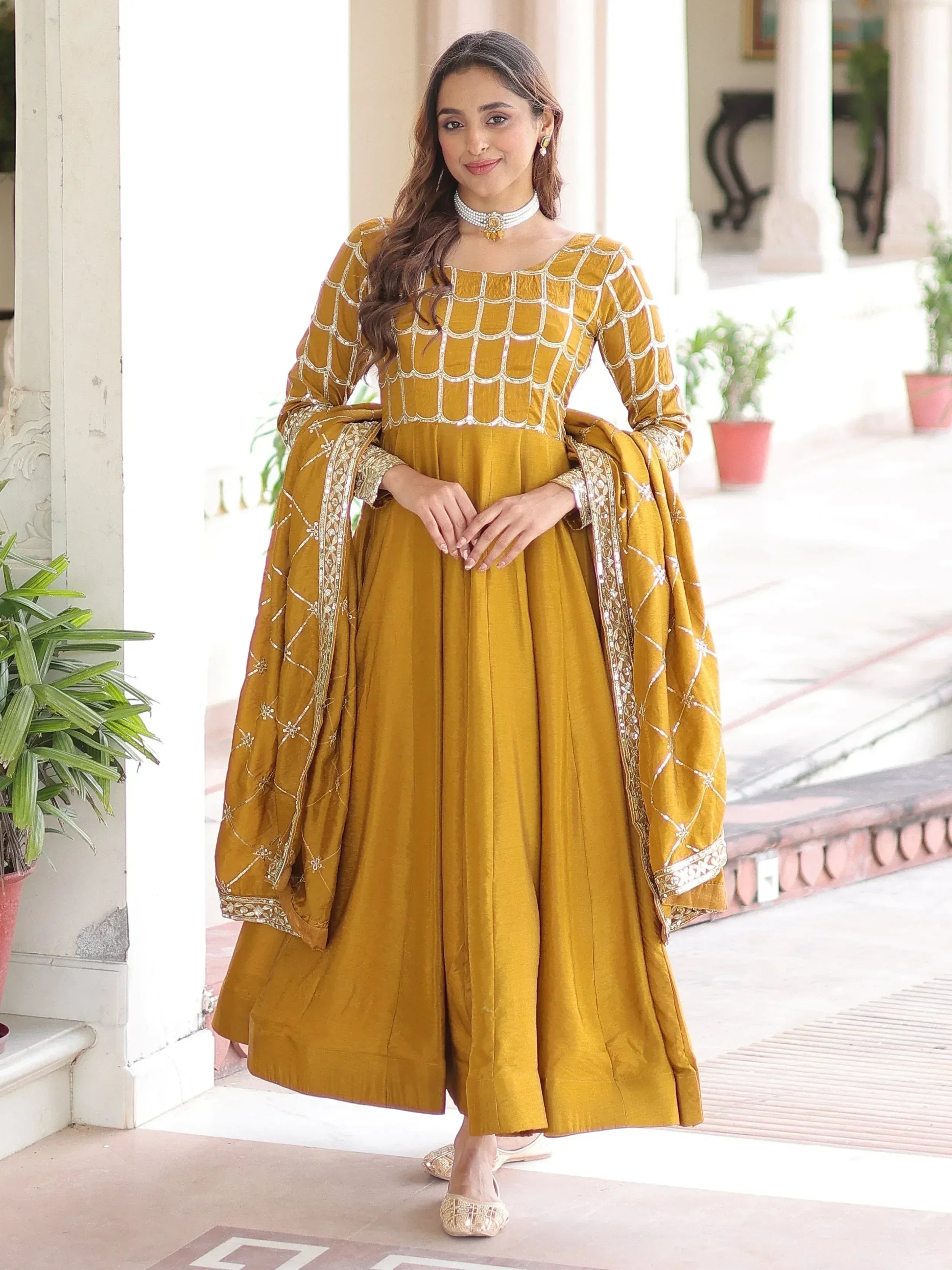 Mustard yellow designer anarkali suit with silver embroidery and matching dupatta, perfect for ethnic occasions