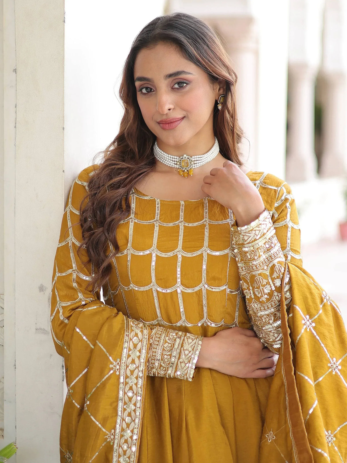 Mustard yellow ethnic gown with silver embroidery, perfect for Indian festive occasions and weddings.