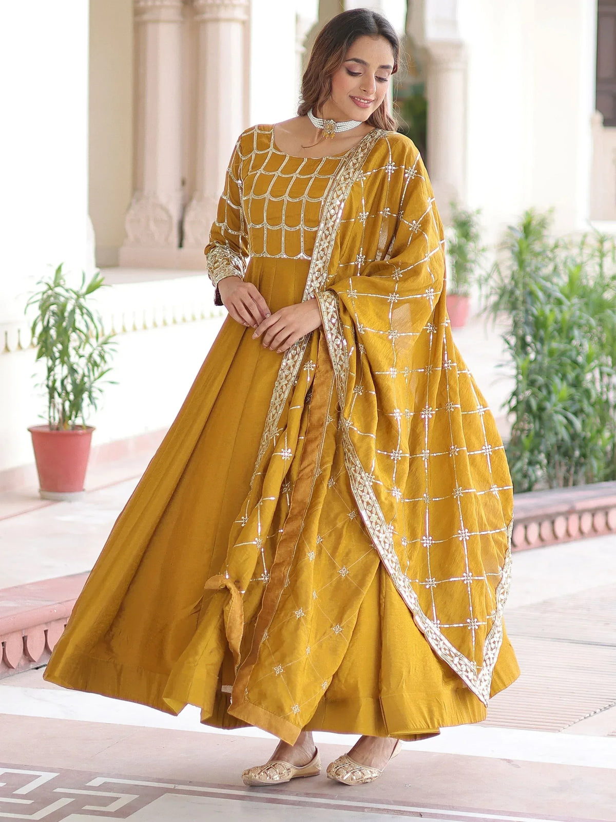 Mustard yellow designer anarkali suit with intricate white embroidery and matching dupatta, perfect for Indian ethnic wear.