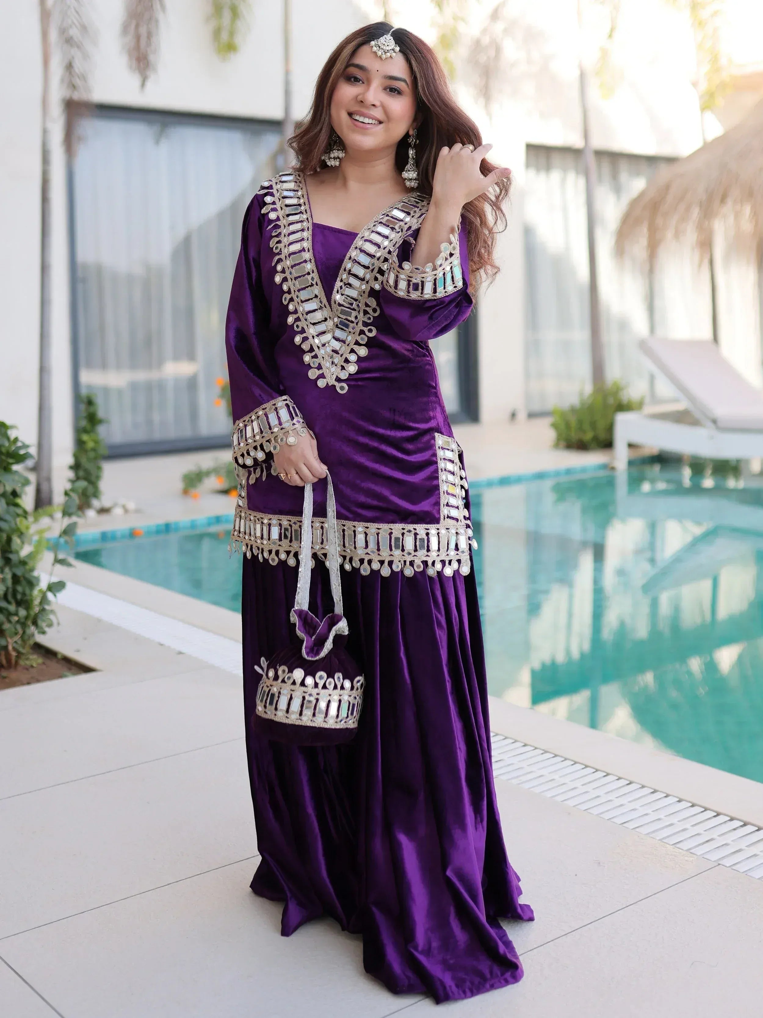 Purple velvet ethnic gown with mirror work, perfect for Indian occasions and parties.