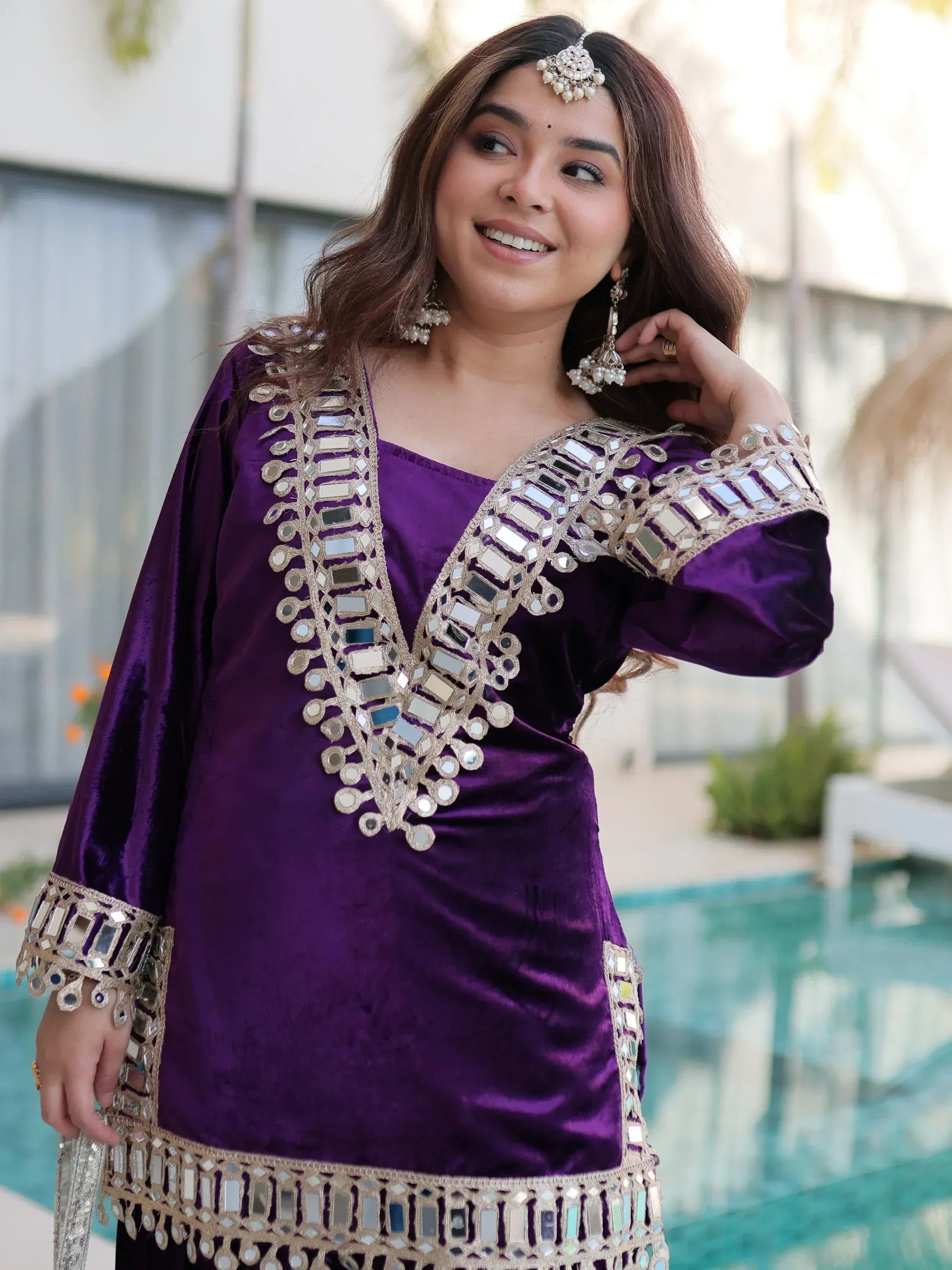 Purple velvet ethnic gown with mirror work, perfect for Indian occasions and festive wear.