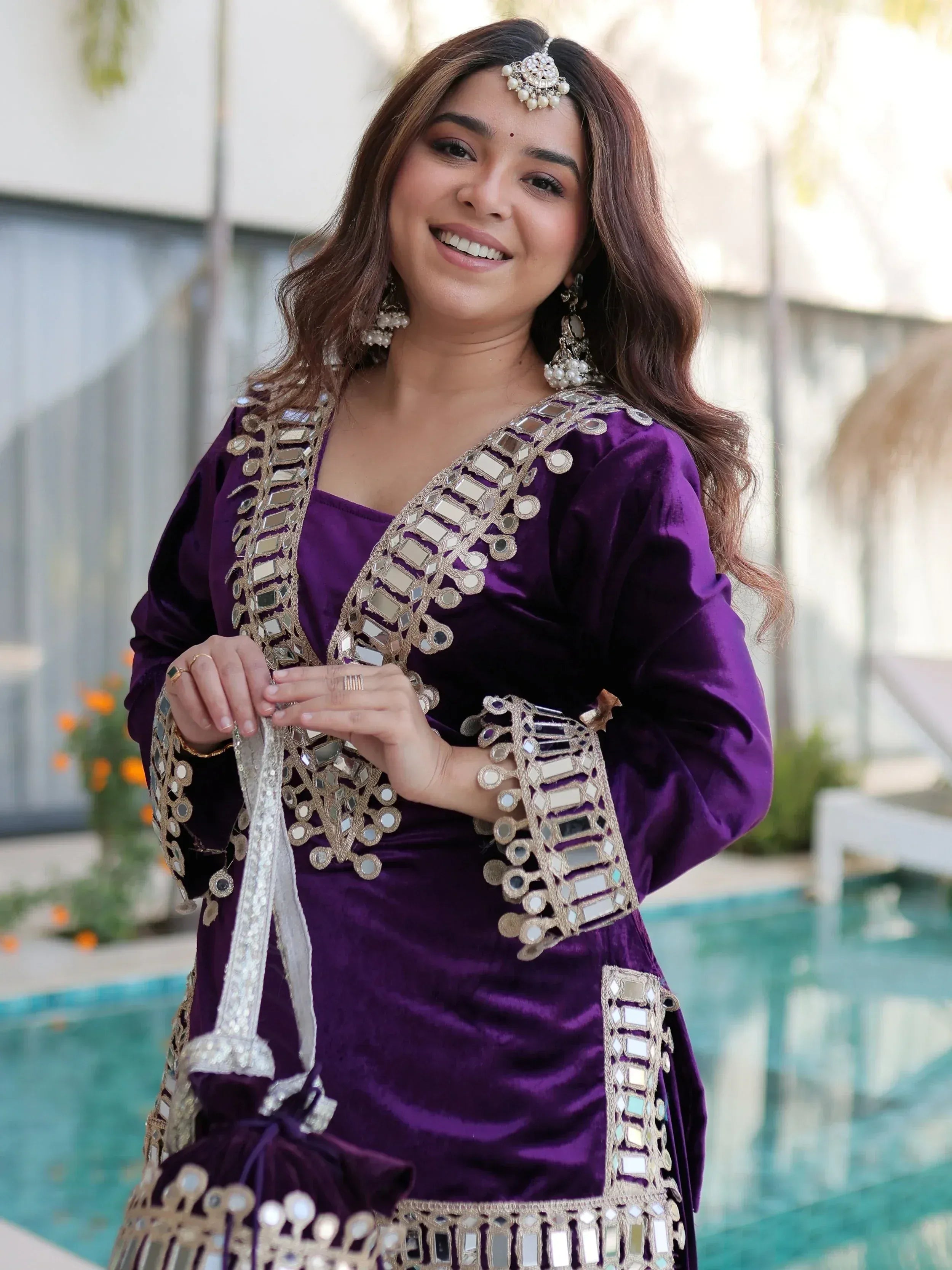 Purple velvet ethnic gown with mirror work, perfect for Indian celebrations and festive occasions.