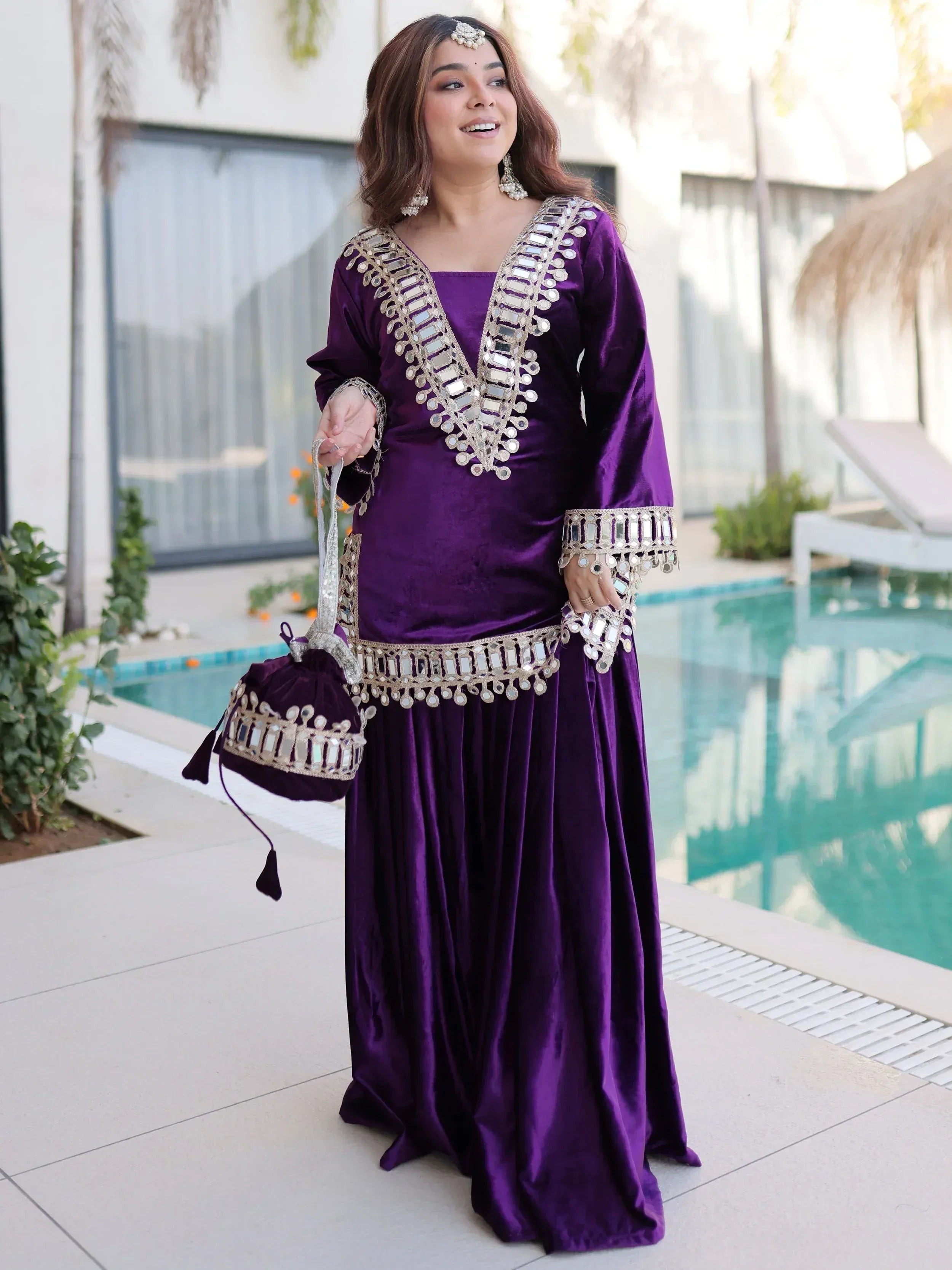 Purple velvet ethnic gown with mirror work, perfect for Indian celebrations and events.