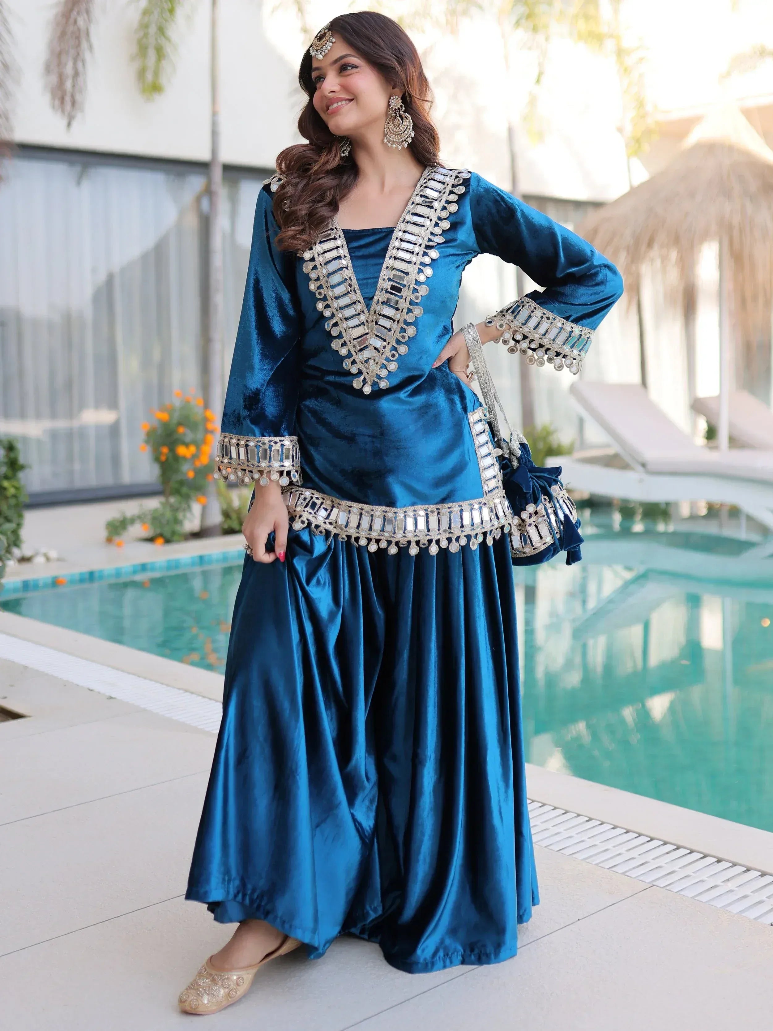 Blue velvet ethnic gown with mirror work, perfect for Indian celebrations and festive occasions.