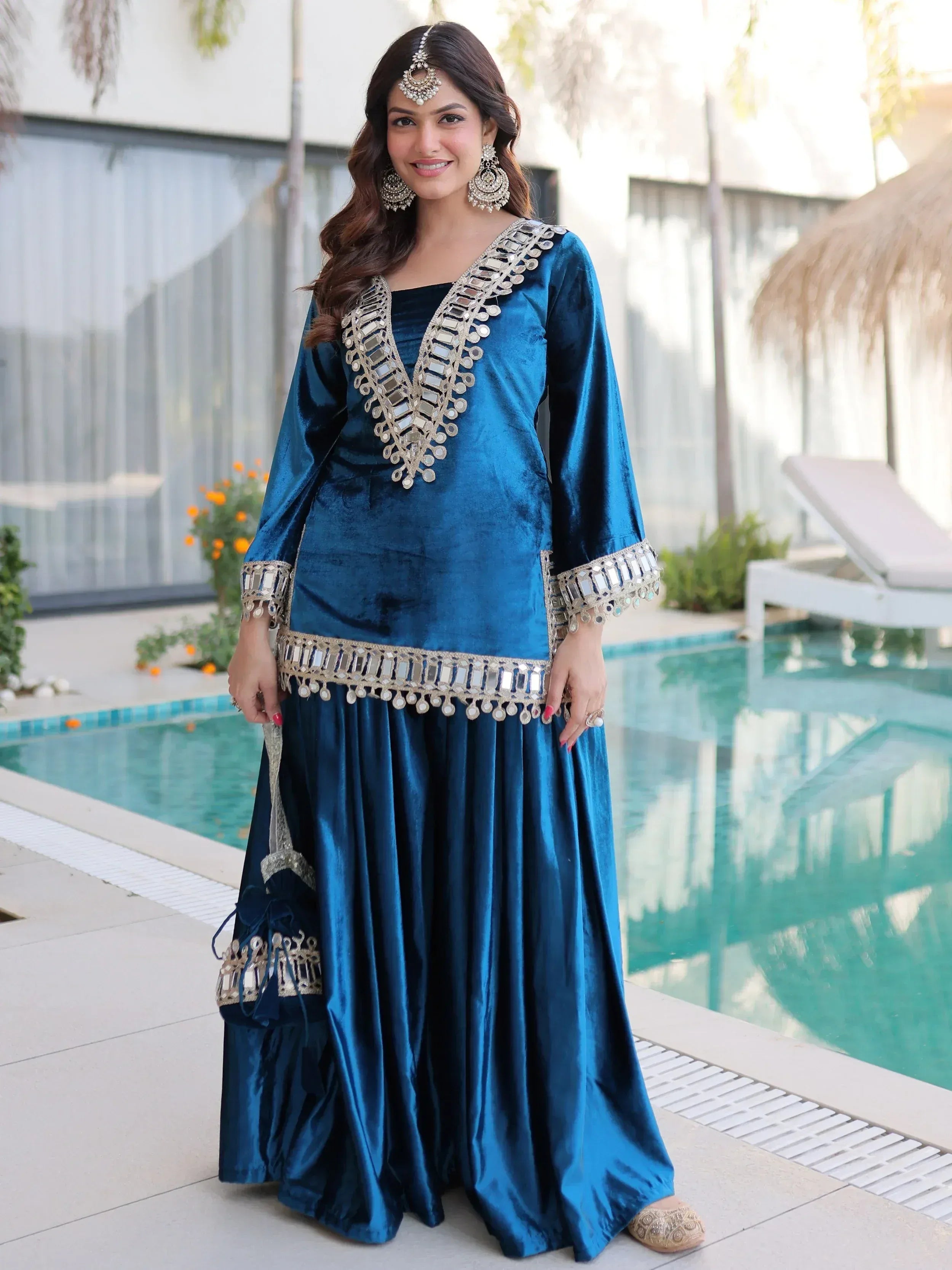 Blue velvet ethnic gown with mirror work, perfect for Indian celebrations and events.