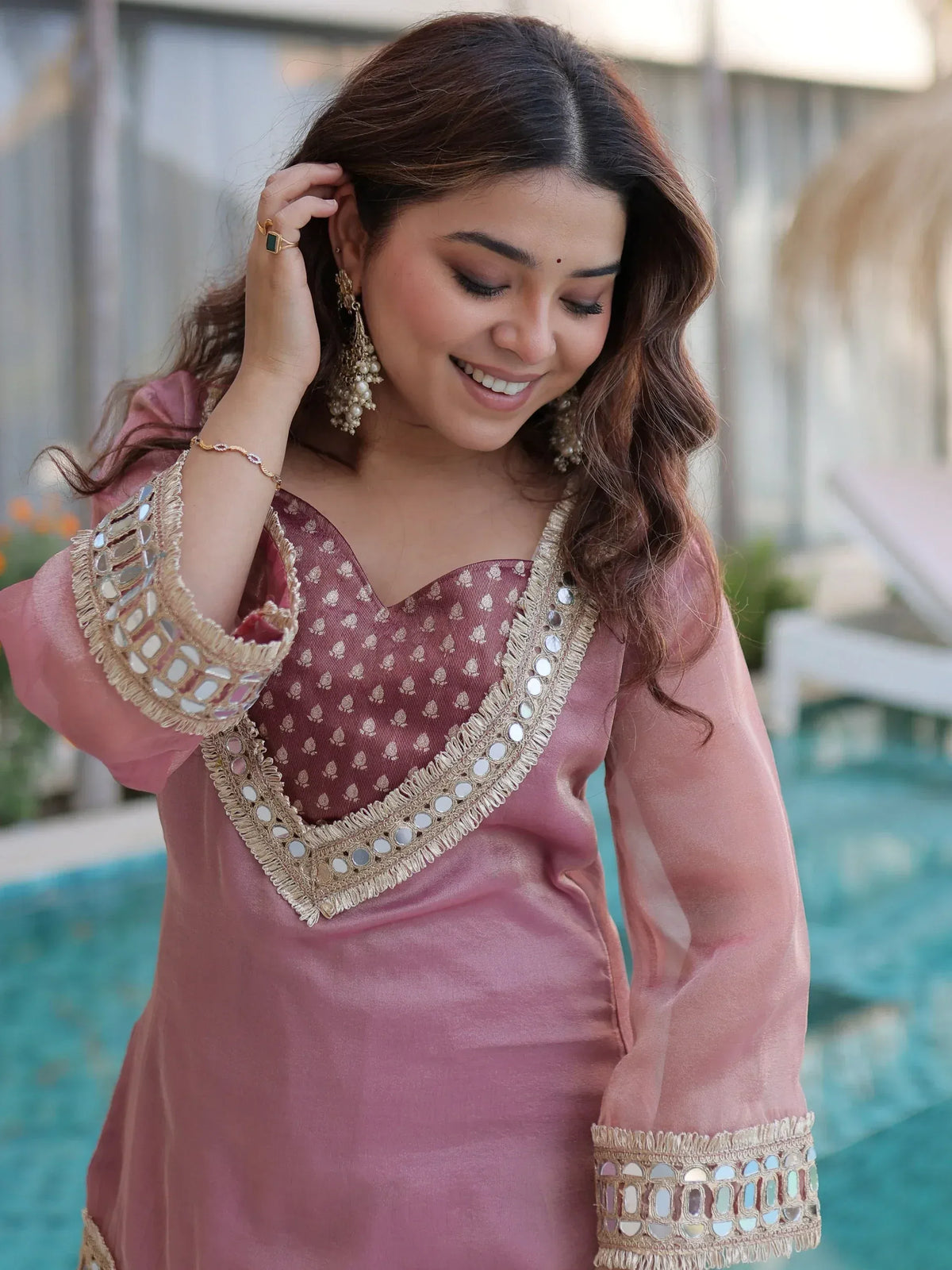 Pink ethnic kurti with mirror work and gold embroidery, perfect for Indian festive wear