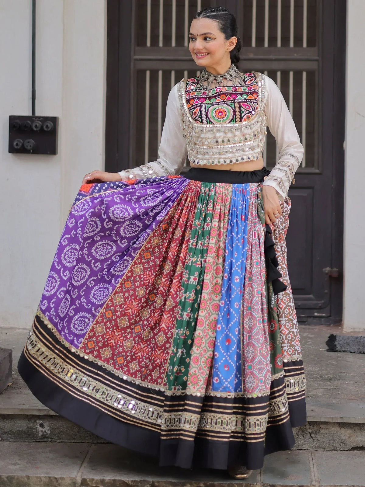 Woman in colorful embroidered lehenga choli with mirror work, Indian ethnic wear