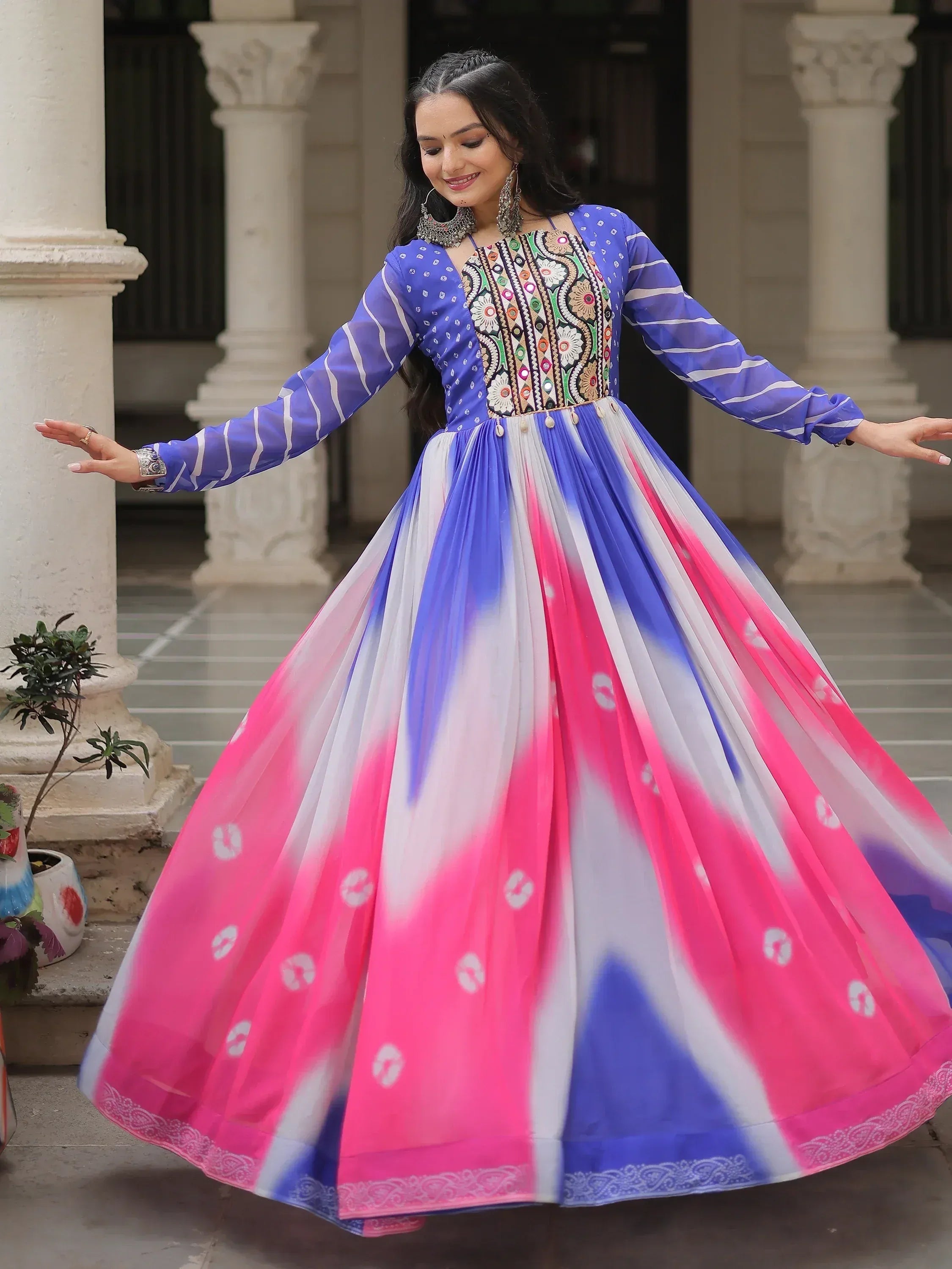 Woman in vibrant blue and pink ethnic gown with embroidered bodice, perfect for Indian festive occasions
