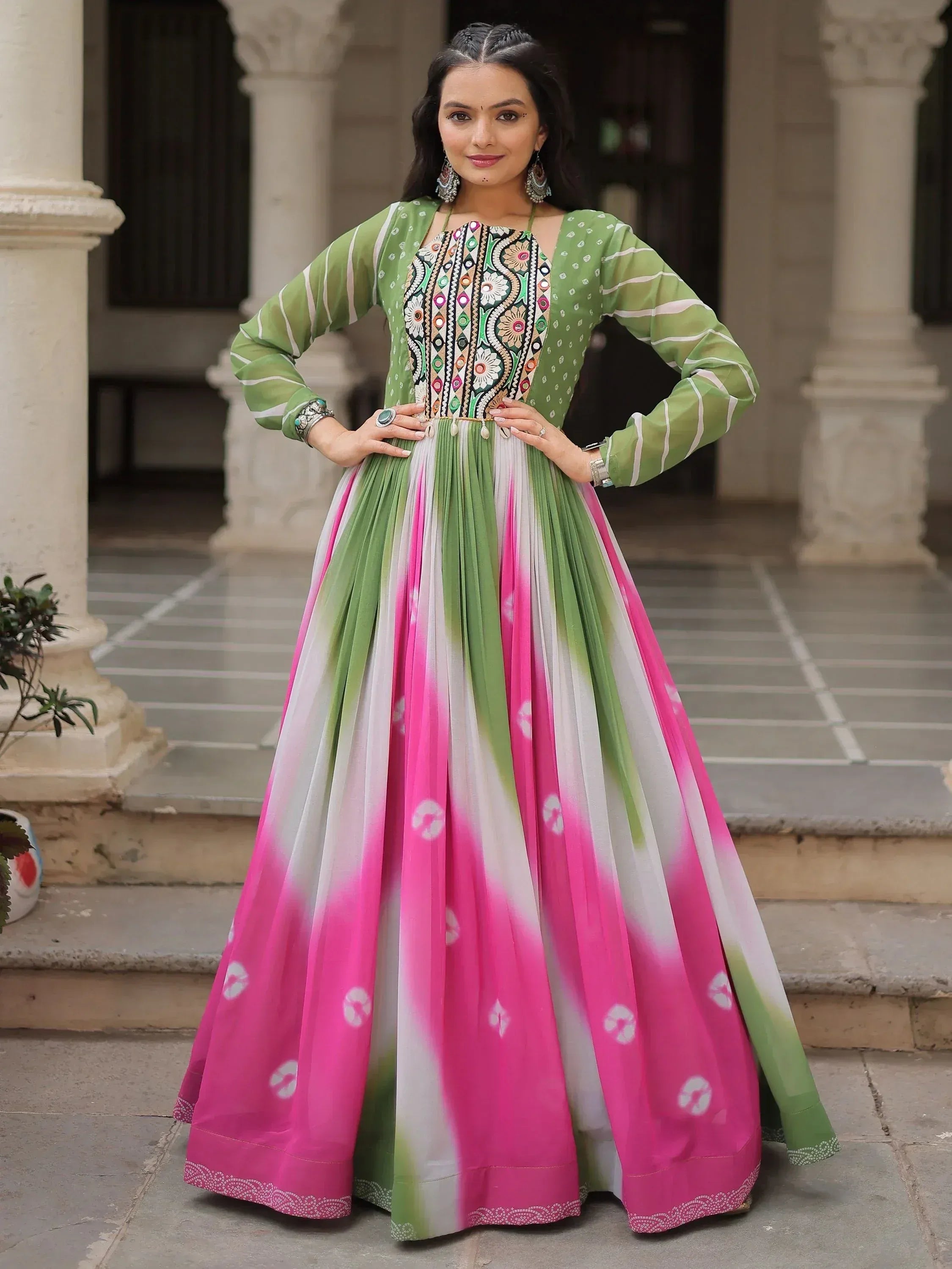Green and pink embroidered ethnic gown with floral patterns, perfect for Indian festive occasions