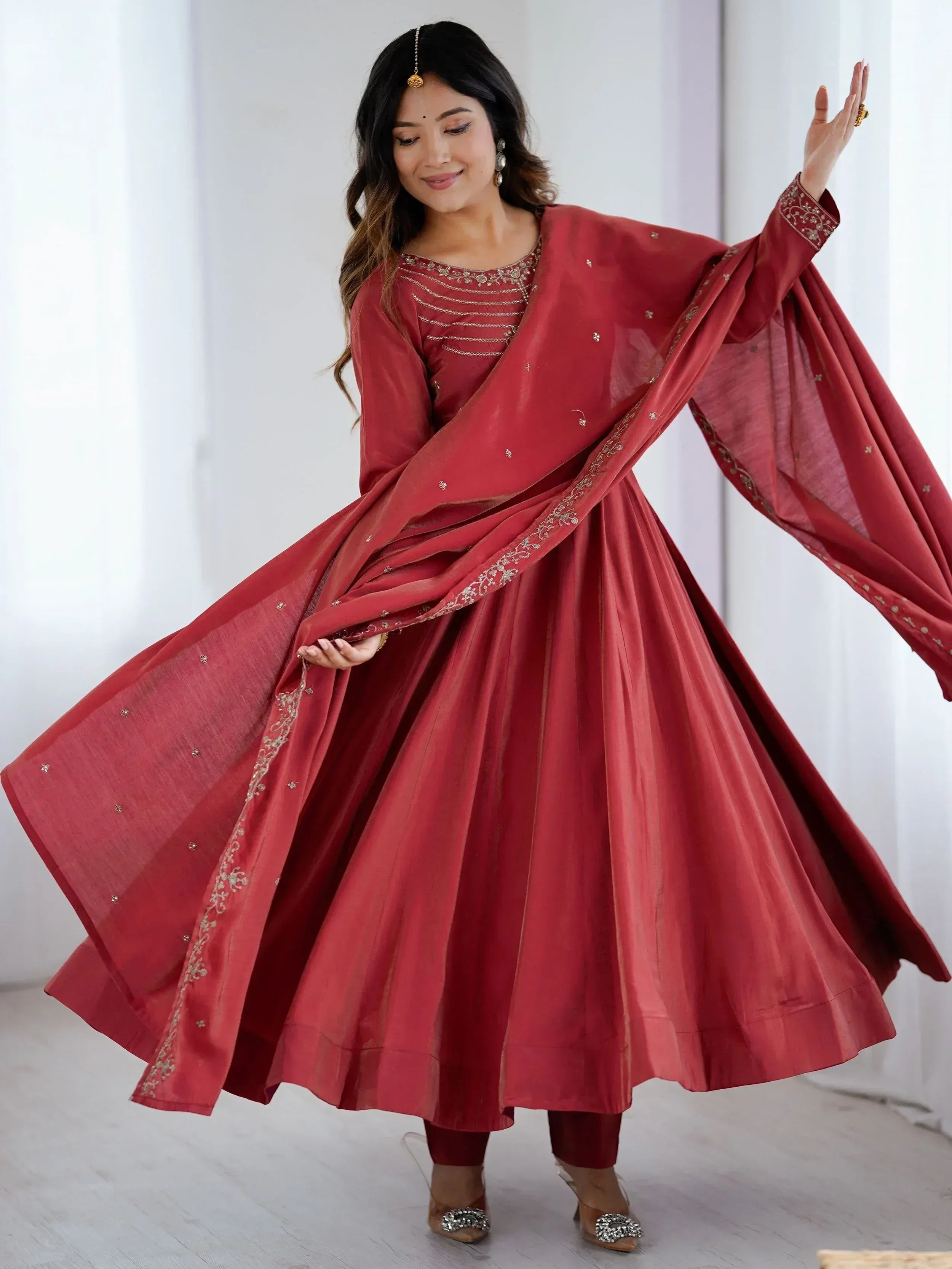 Elegant red ethnic anarkali with gold embroidery and flowing dupatta for festive occasions