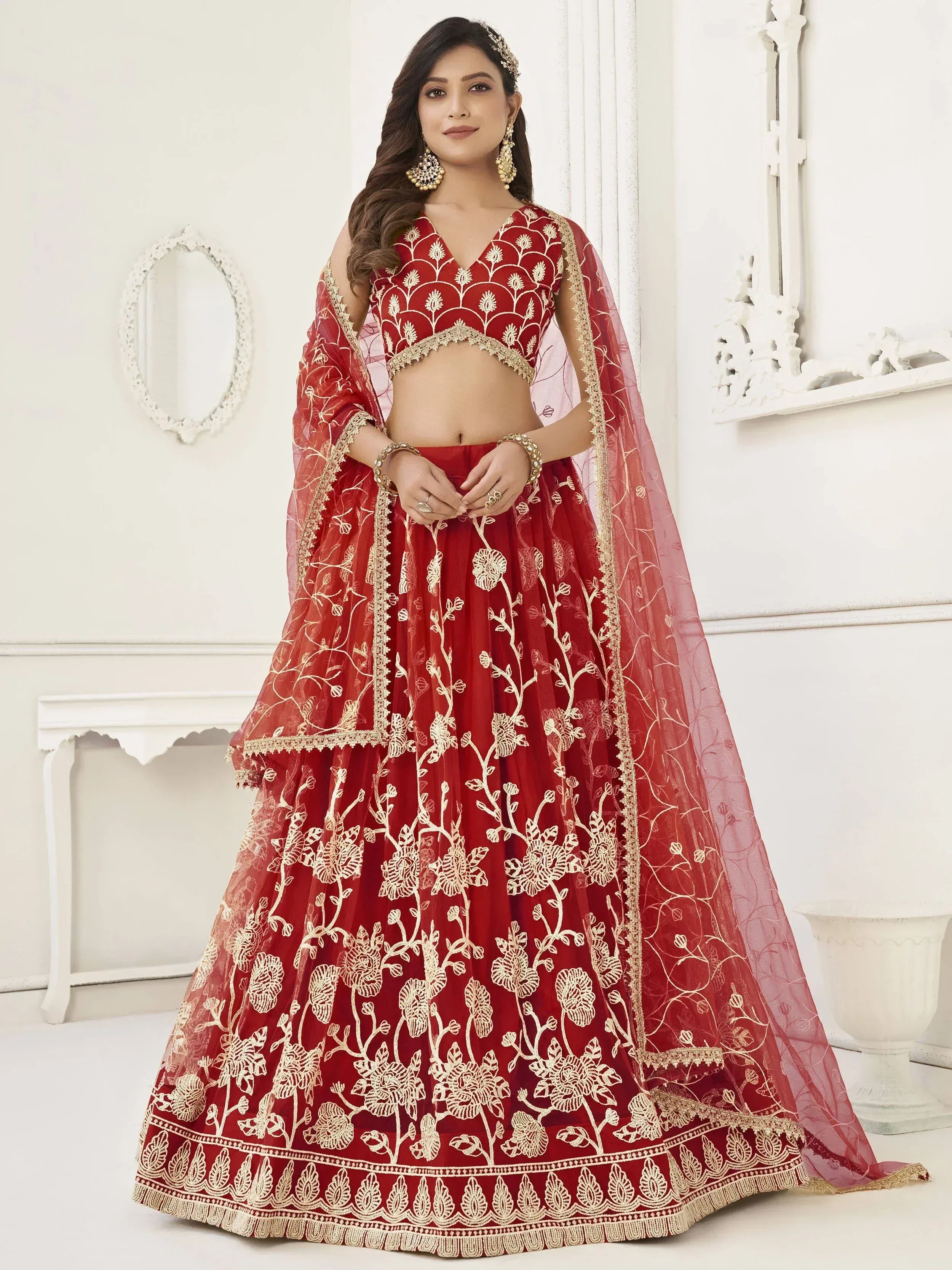 Red embroidered lehenga choli with gold floral work, perfect for Indian weddings and festive occasions.