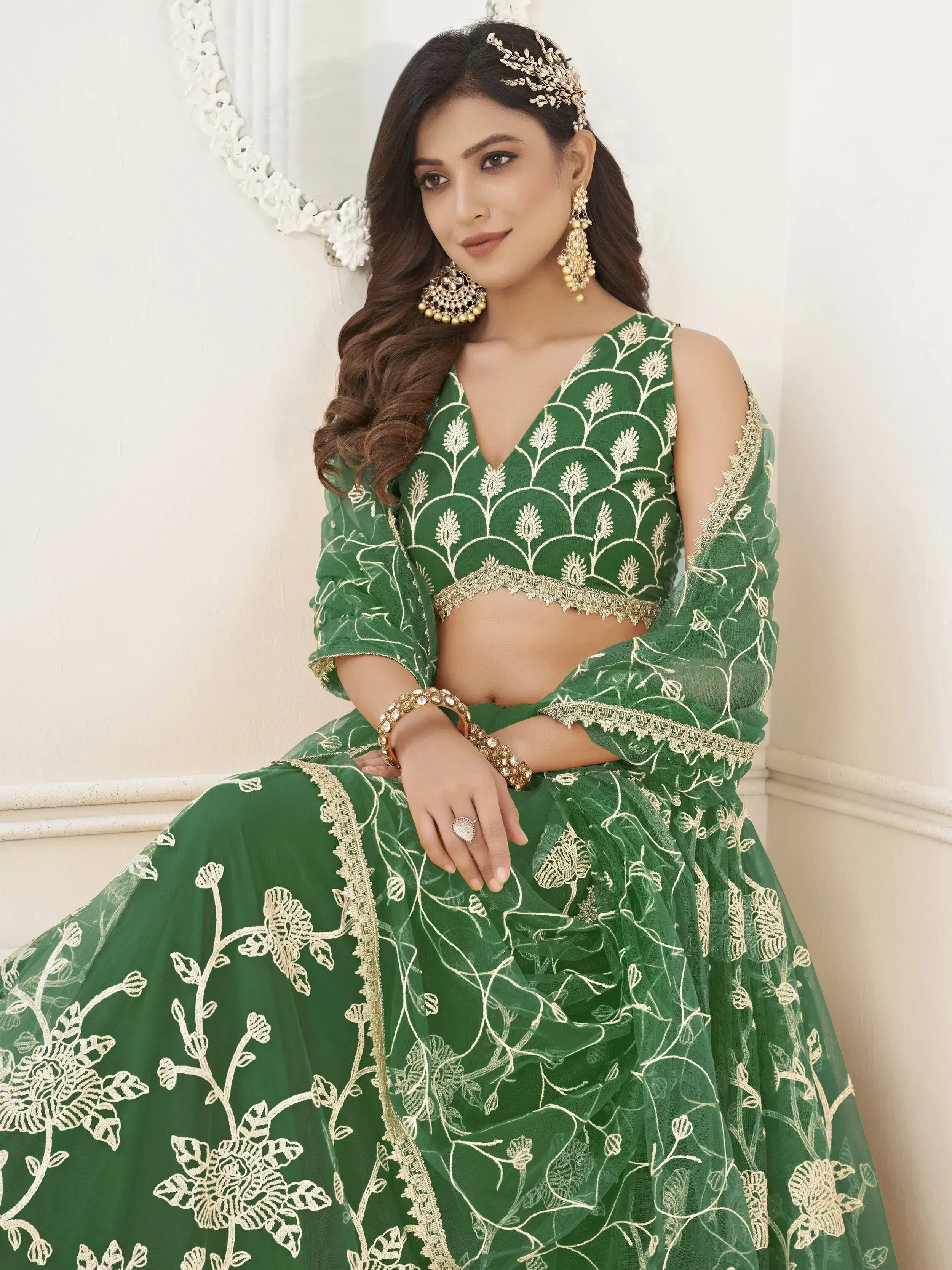 Green embroidered lehenga choli with gold floral work, perfect for Indian weddings and festive occasions.