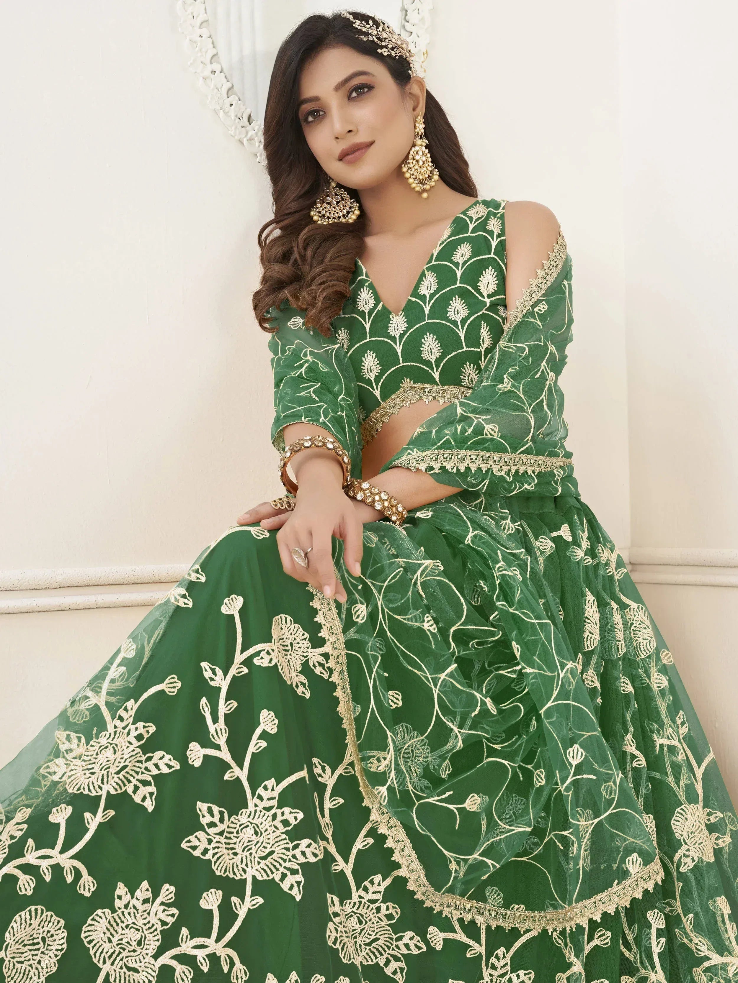 Green embroidered lehenga choli with gold floral work, perfect for Indian weddings and festive occasions.
