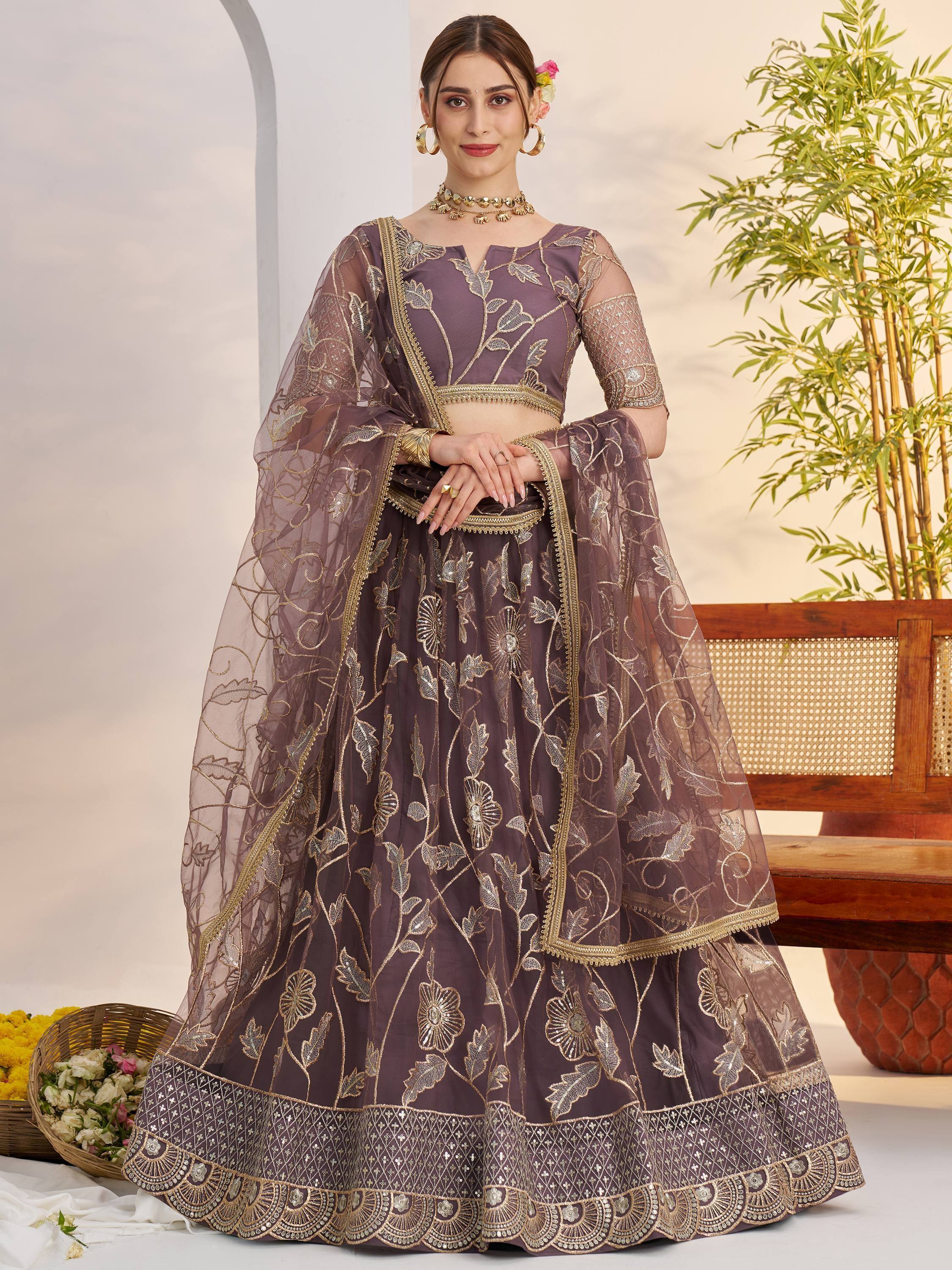 Purple embroidered lehenga choli with gold floral work, perfect for Indian weddings and festive occasions.
