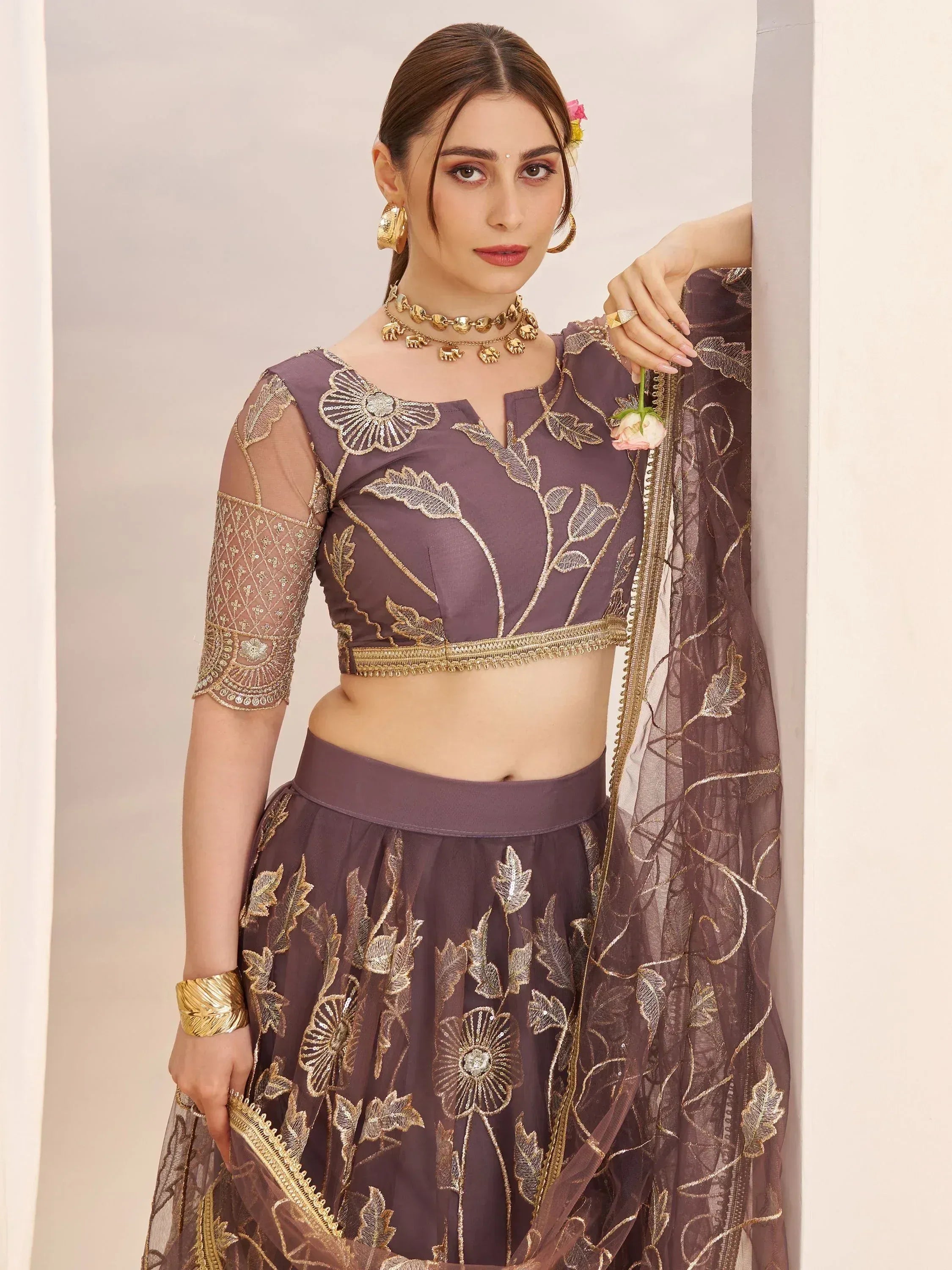 Purple embroidered lehenga choli with gold floral work, sheer sleeves, and matching dupatta for Indian ethnic wear