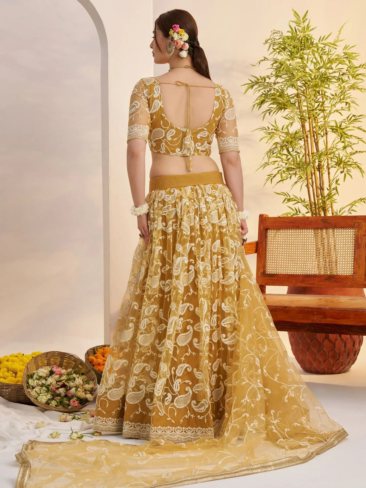 Elegant mustard yellow lehenga choli with white paisley embroidery, perfect for Indian ethnic wear.