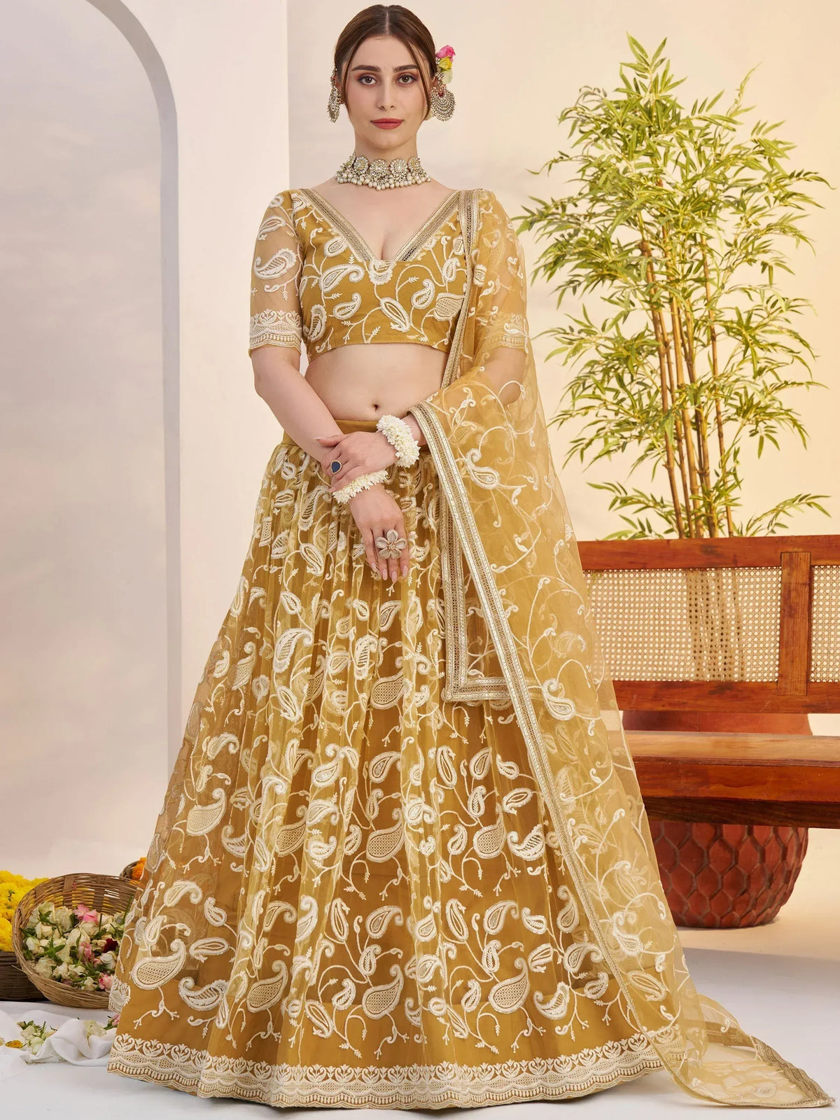 Mustard yellow embroidered lehenga choli with paisley design, perfect for Indian weddings and festive occasions.
