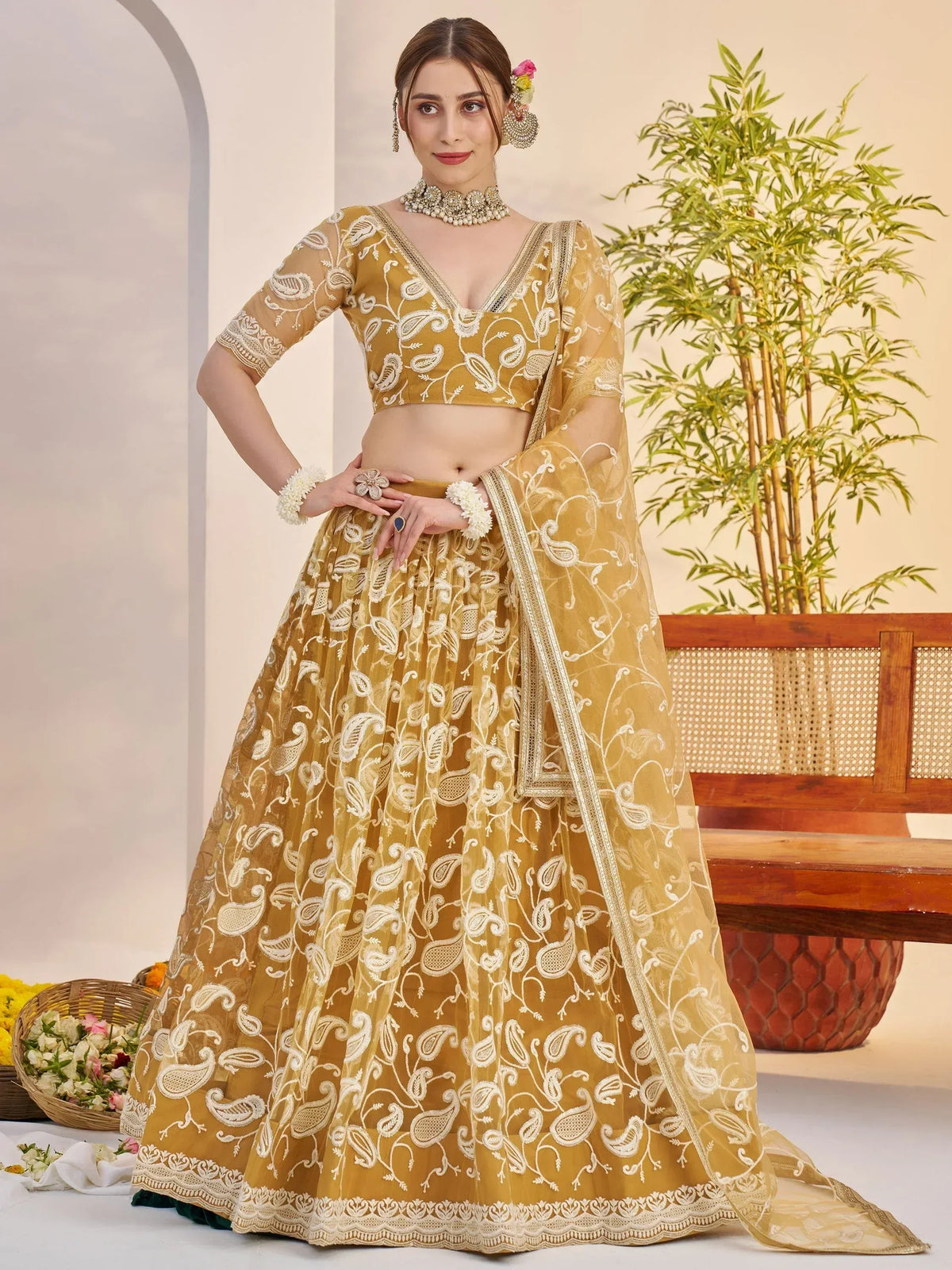 Elegant mustard yellow lehenga choli with white paisley embroidery, perfect for Indian ethnic wear.